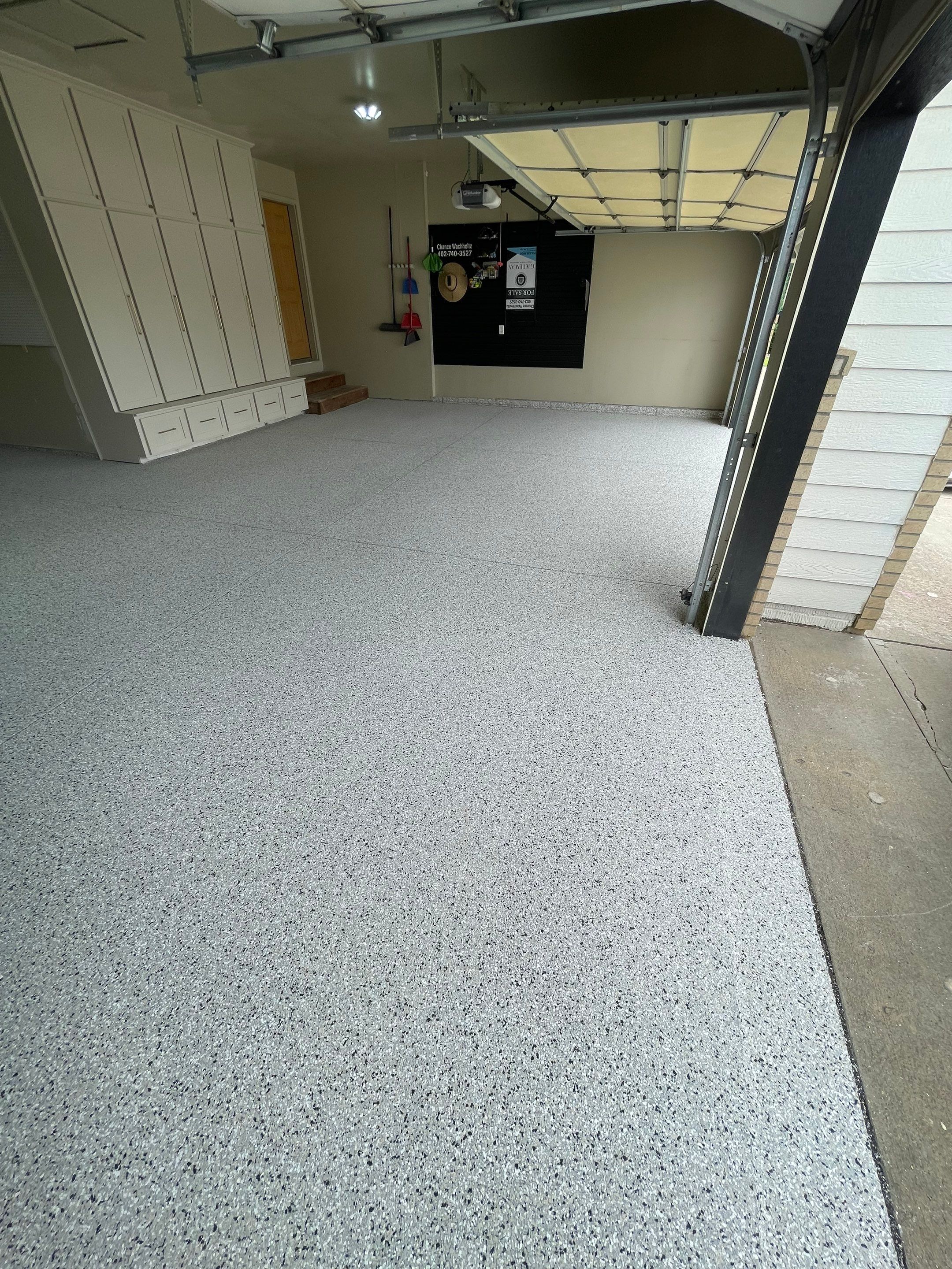 Cabin FEver Flake Garage Floor Coating Installation in Sioux Falls by Select Painting, Coatings & Garage Cabinets