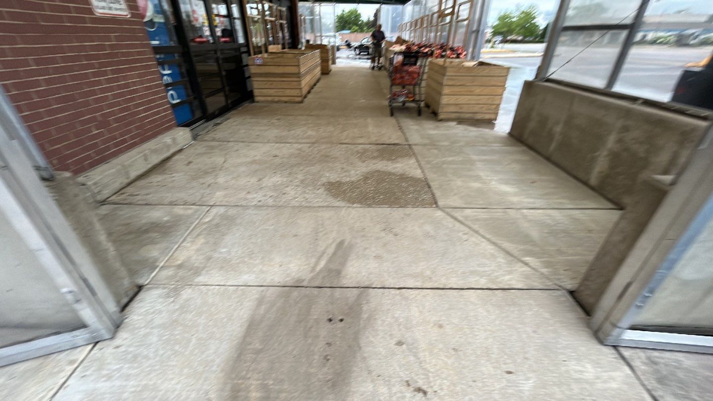 Concrete sidewalk cleaning and degreasing by Northern Power Washing LLC.
