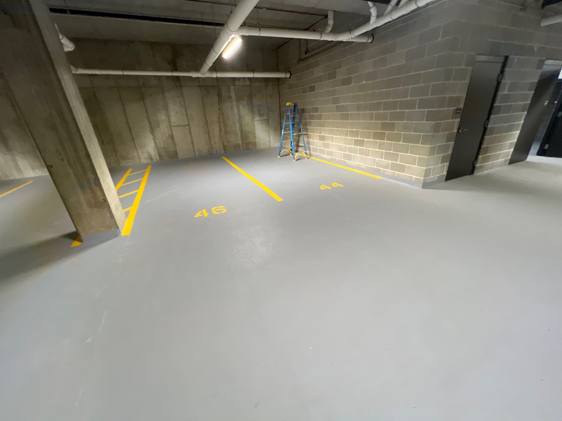 Parking garage using Hot water by Northern Power Washing LLC.