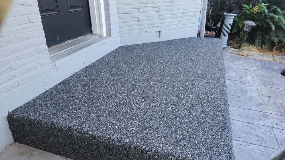 Charming Compact Patio in Vuba Stone by Concrete Coating Experts Inc.