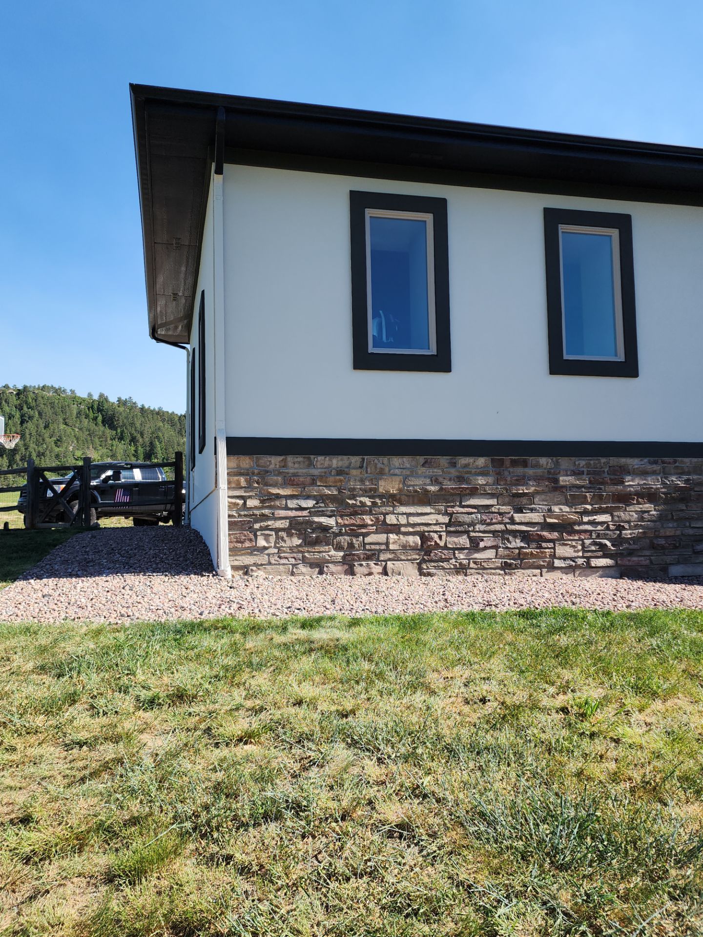 Castle Rock Elegance: White Stucco Exterior with Bold Tricorn Black by J&M Painting LLC