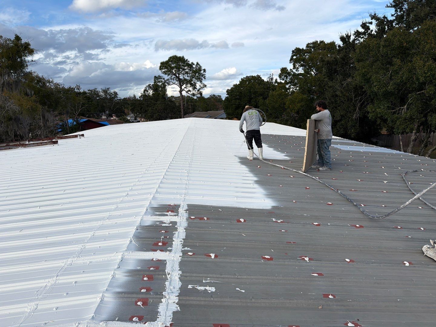 Industrial Metal Roof Restoration With Silicone Coating in Winter Park by CES Roofing