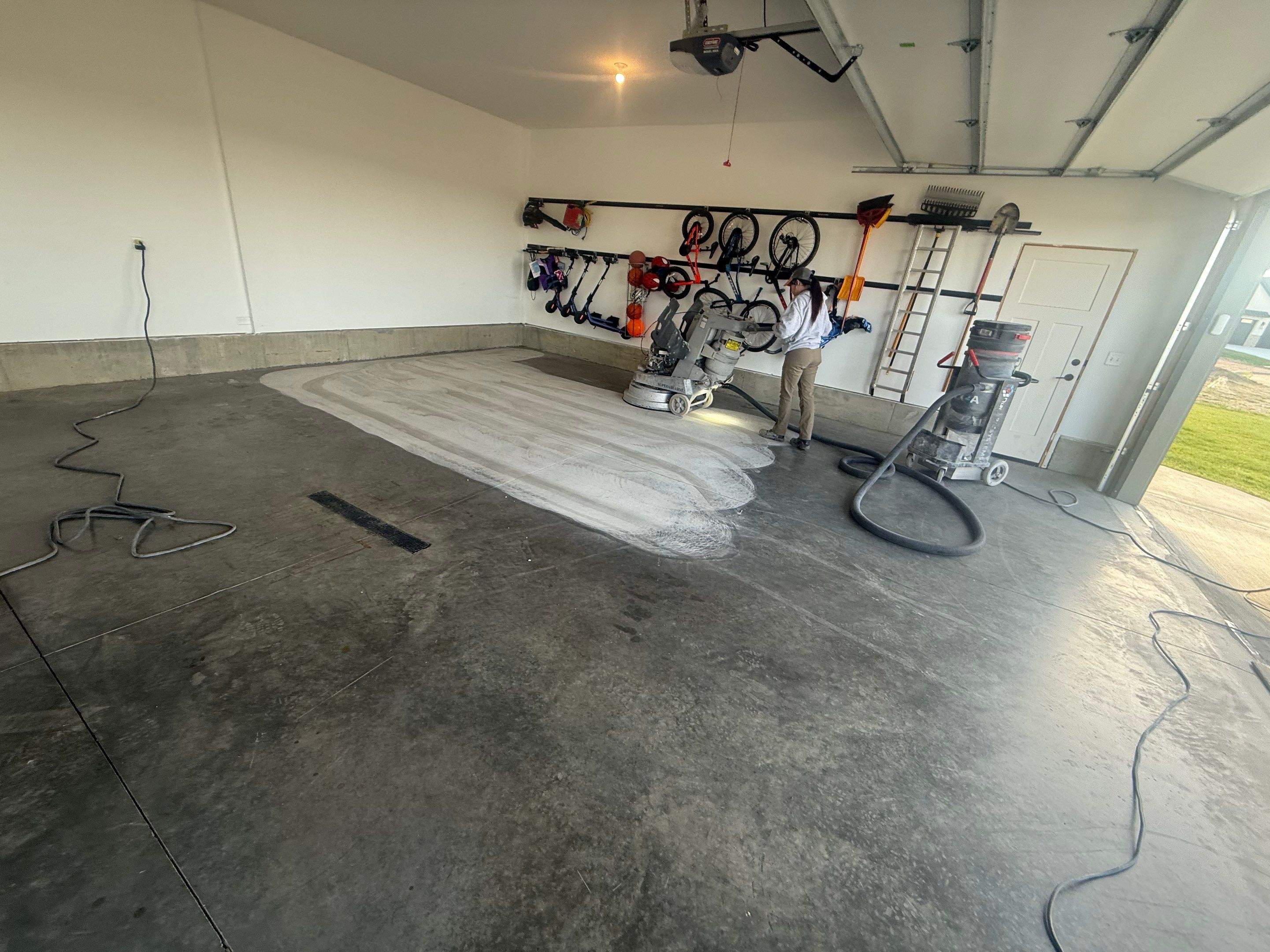 Full Garage Concrete Coating with Grey Speckled Epoxy in Brandon by Select Painting, Coatings & Garage Cabinets