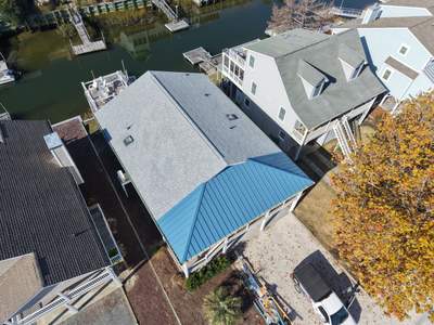 Standing Seam Metal Roof & Silver Birch Shingle Upgrade in Sunset Beach, NC by RGR Construction and Roofing, LLC
