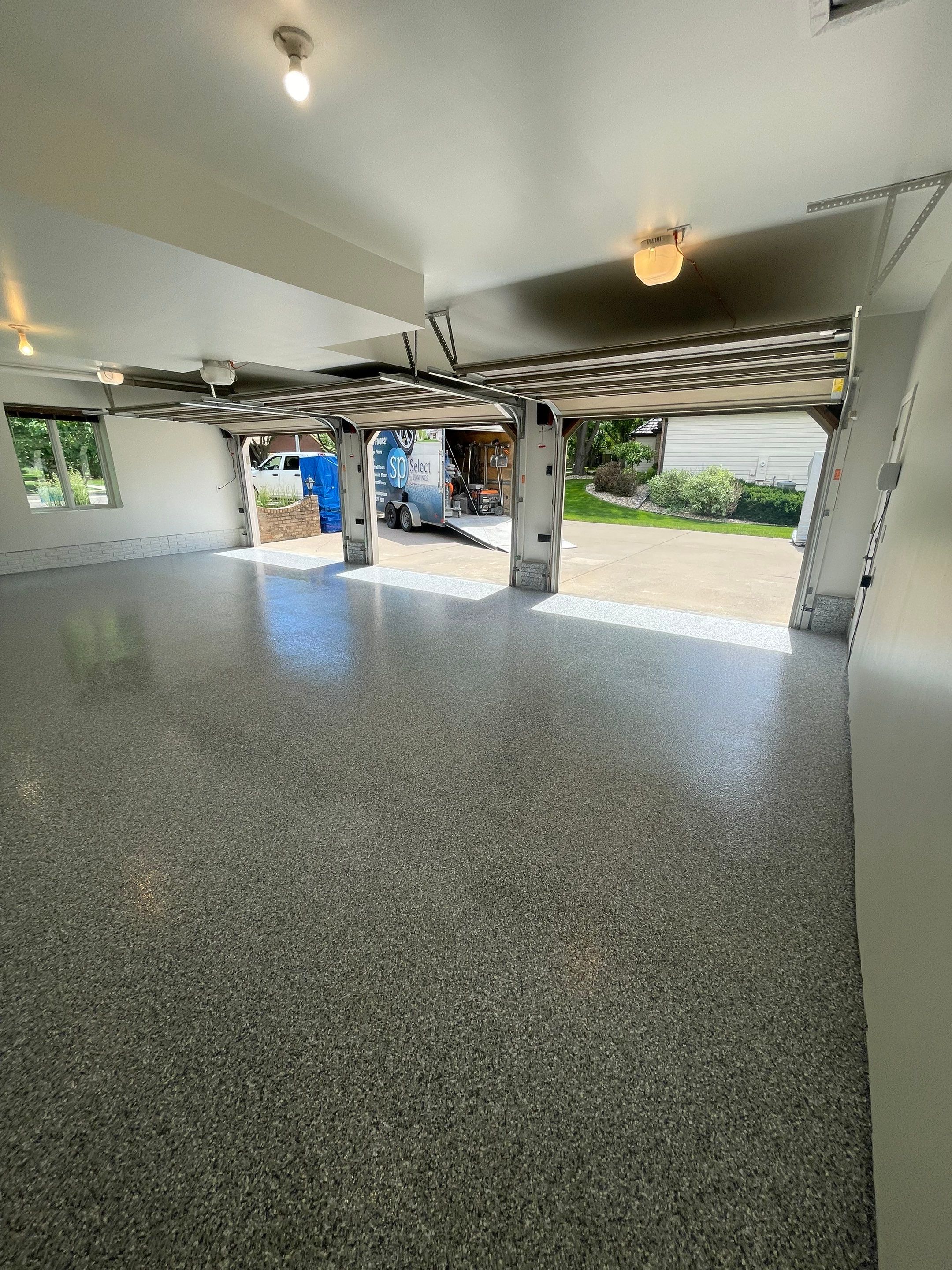 Gray Speckled Epoxy Garage Floor Coating in Sioux Falls by Select Painting, Coatings & Garage Cabinets