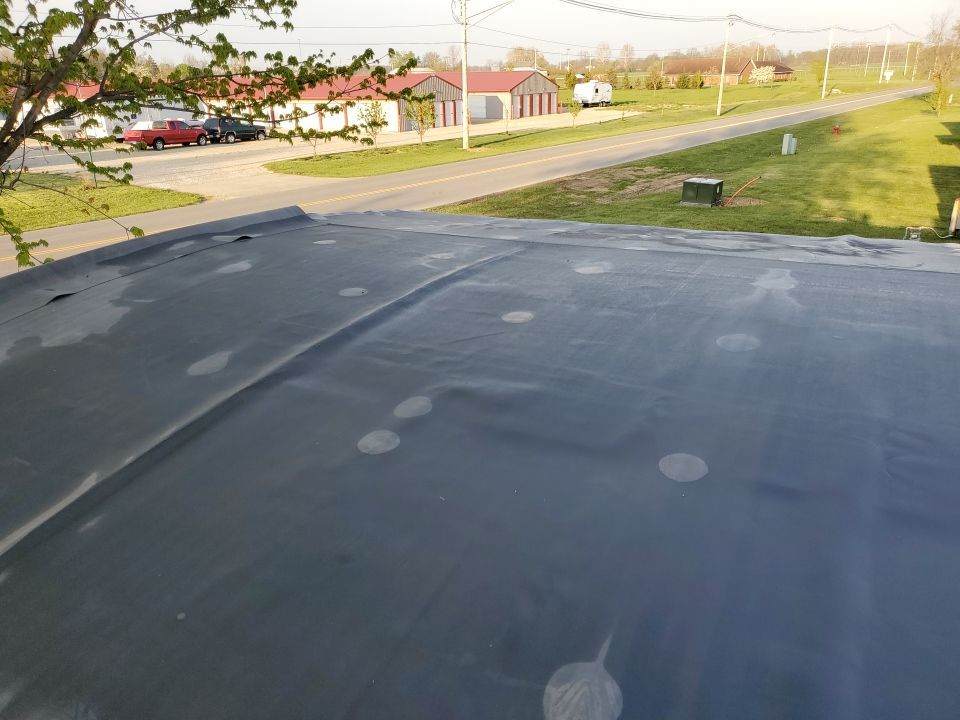 Residential Roofing Installation using 60 mil rubber roof  by Nitro Roofing and Construction