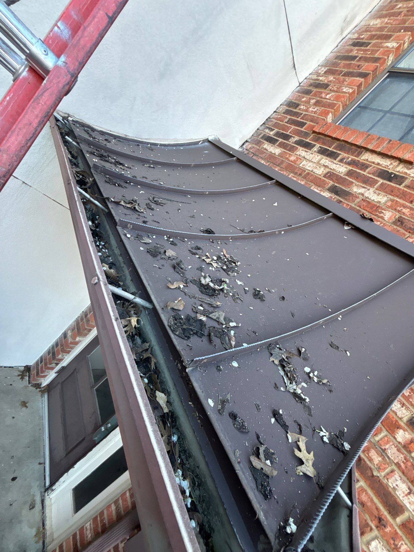 Commercial gutter cleaning Memphis, TN before photo with filled gutters