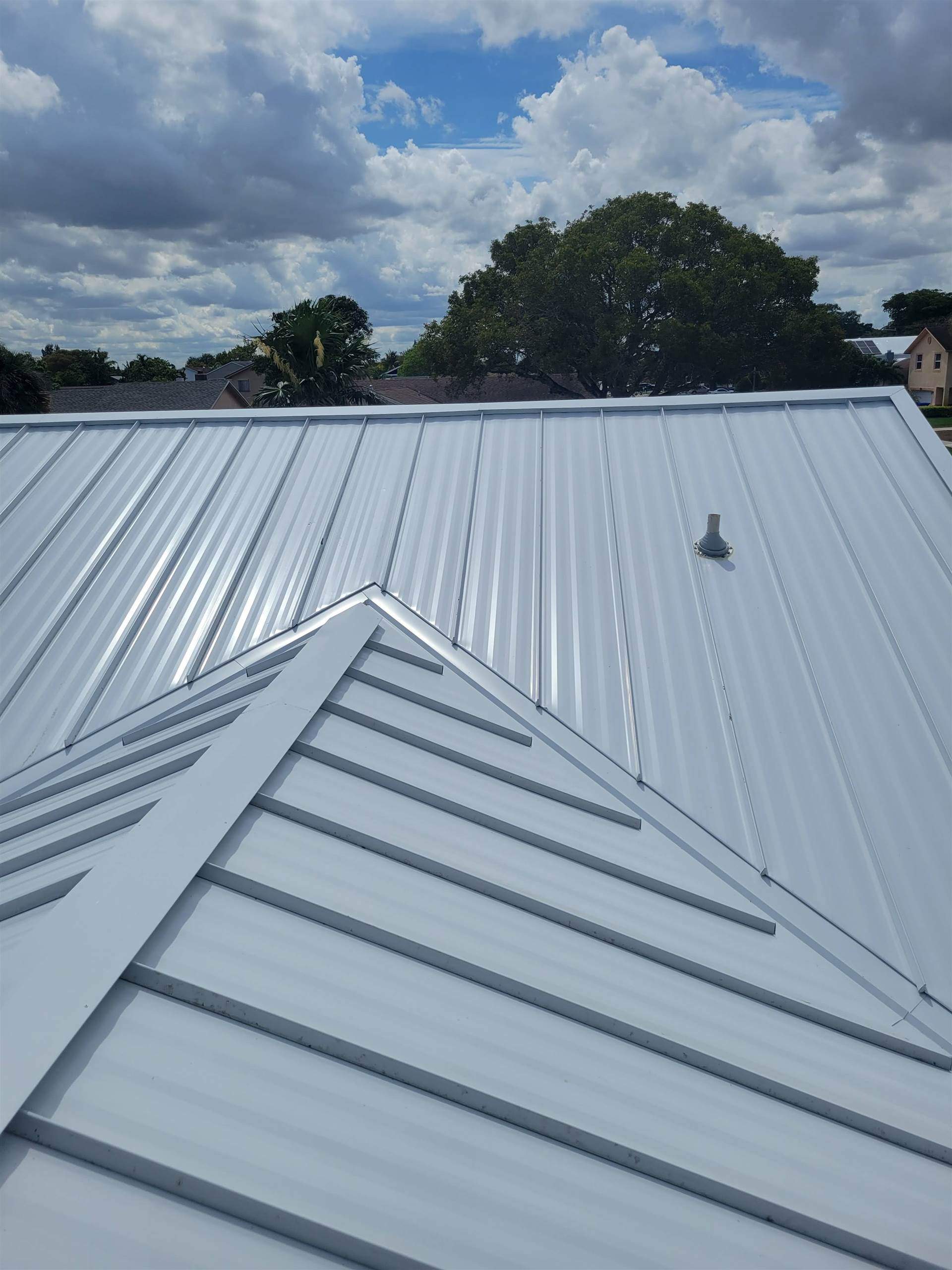 Standing Seam Metal & Flat Re-Roof using 1.5" Nail Strip 24ga Solar White Kynar Coated Standing Seam Metal Panels by Morton Roofing, Inc.