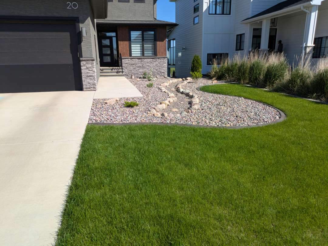 Decorative Concrete Curbing and River Rock Landscape Installation by Pump it Up Concrete Jacking