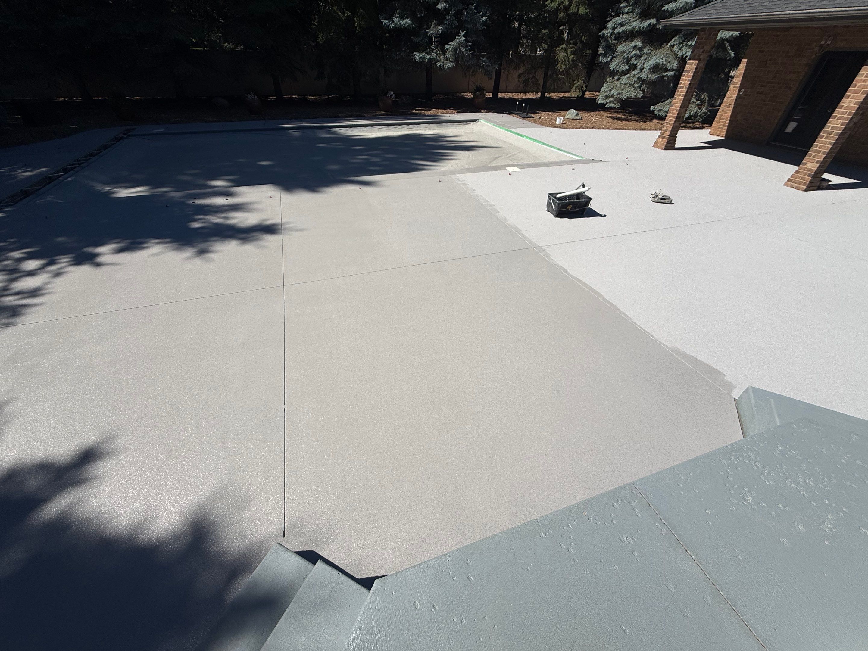 Decorative Concrete Pool Deck and Patio Resurfacing in Sioux Falls by Select Painting, Coatings & Garage Cabinets