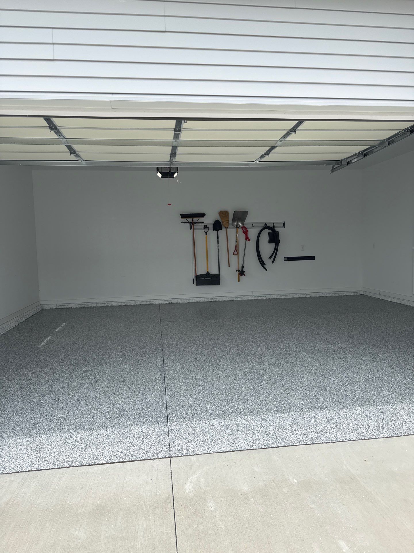 Gravel Flake Garage and Patio Floor Coating for Boone Residence by Revival Concrete Coatings