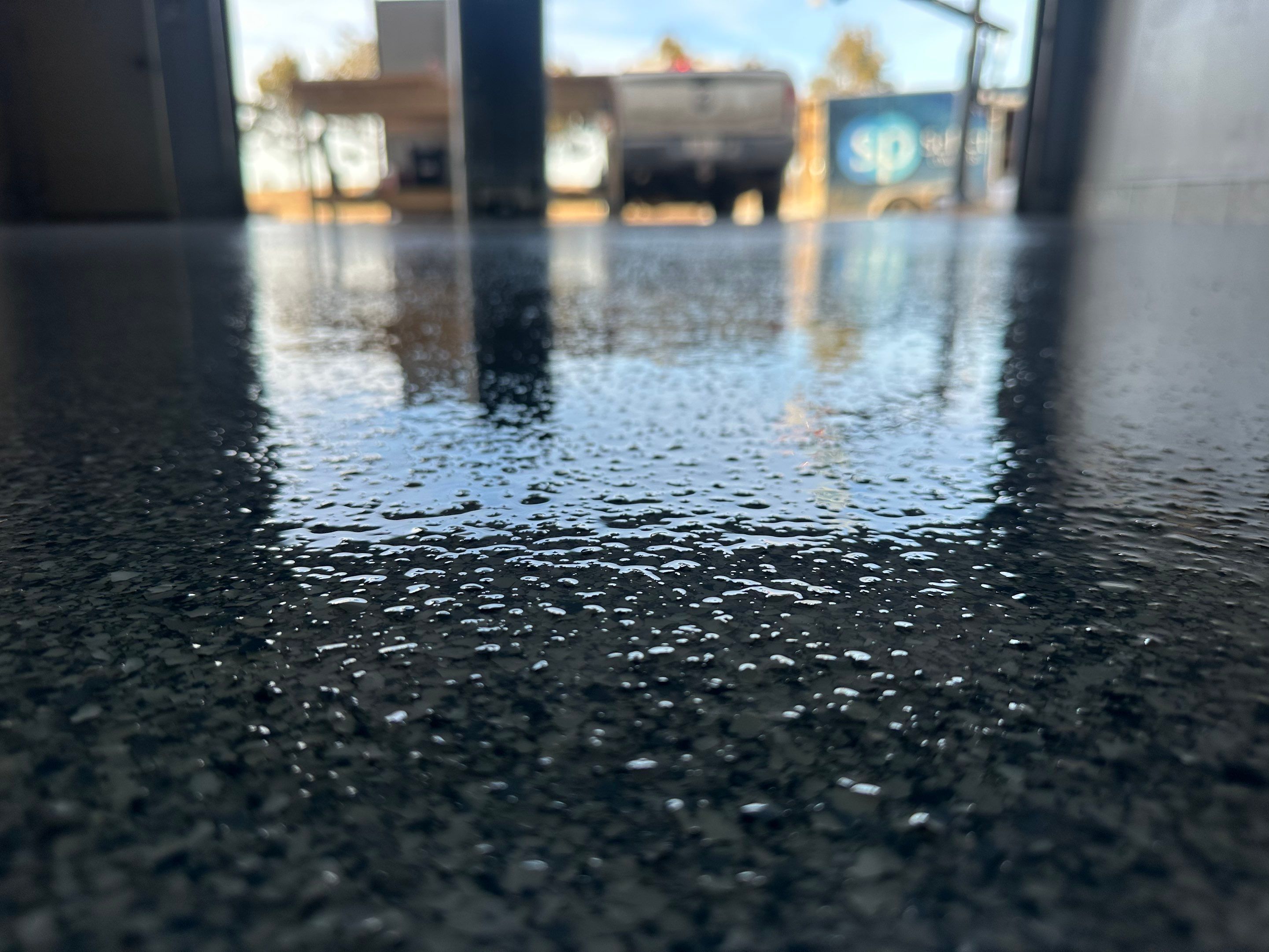 Multi-Colored Speckled Concrete Floor Coating Installation in Sioux Falls by Select Painting, Coatings & Garage Cabinets