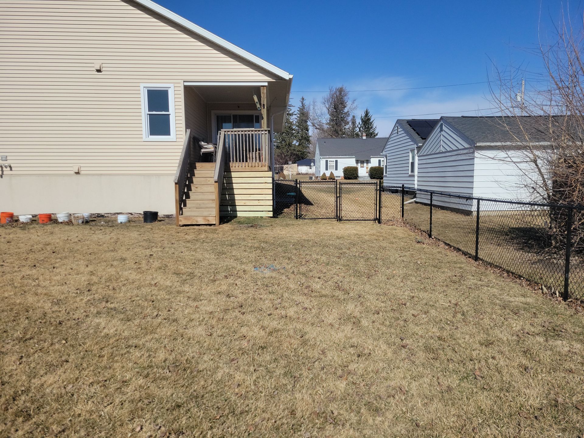 Residential Black Chain Link Fence and Gate Installation in Tripoli by Perfect Picket Fence and Stain