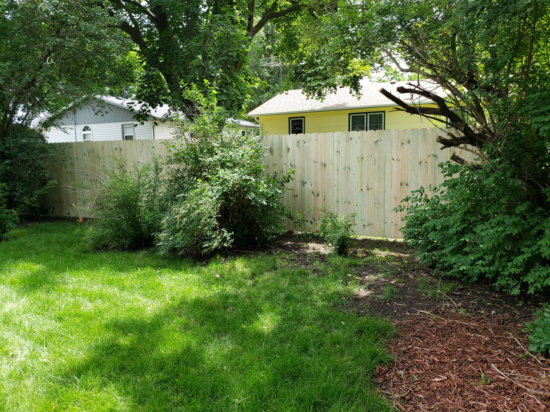 Custom Wood Privacy Fence Installation for Charles City Backyard by Perfect Picket Fence and Stain