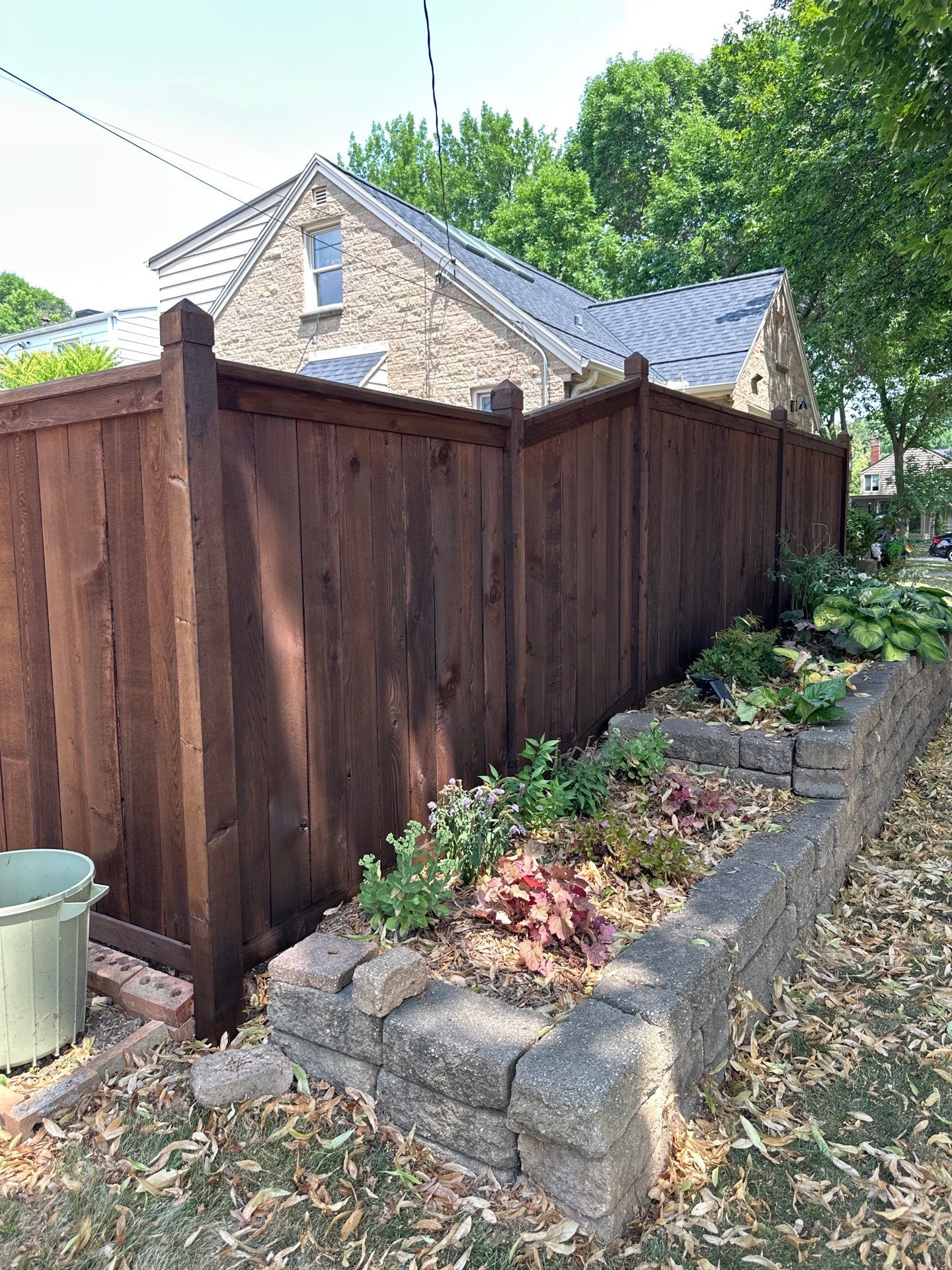 Dark Stained Privacy Fence and Composite Deck in Milwaukee by OCS Contracting Services