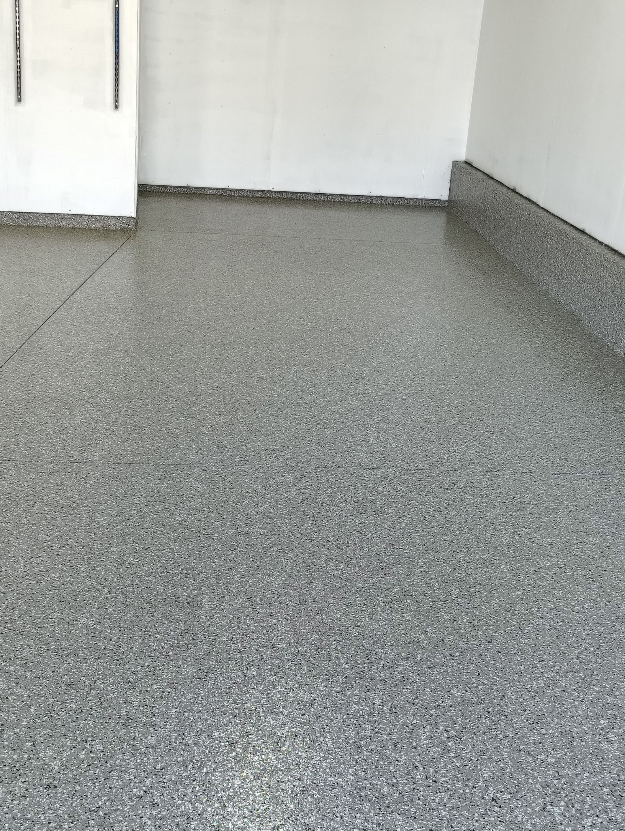 Sioux Falls Garage Floor Transformation With Gray Speckled Epoxy Coating by Select Painting, Coatings & Garage Cabinets