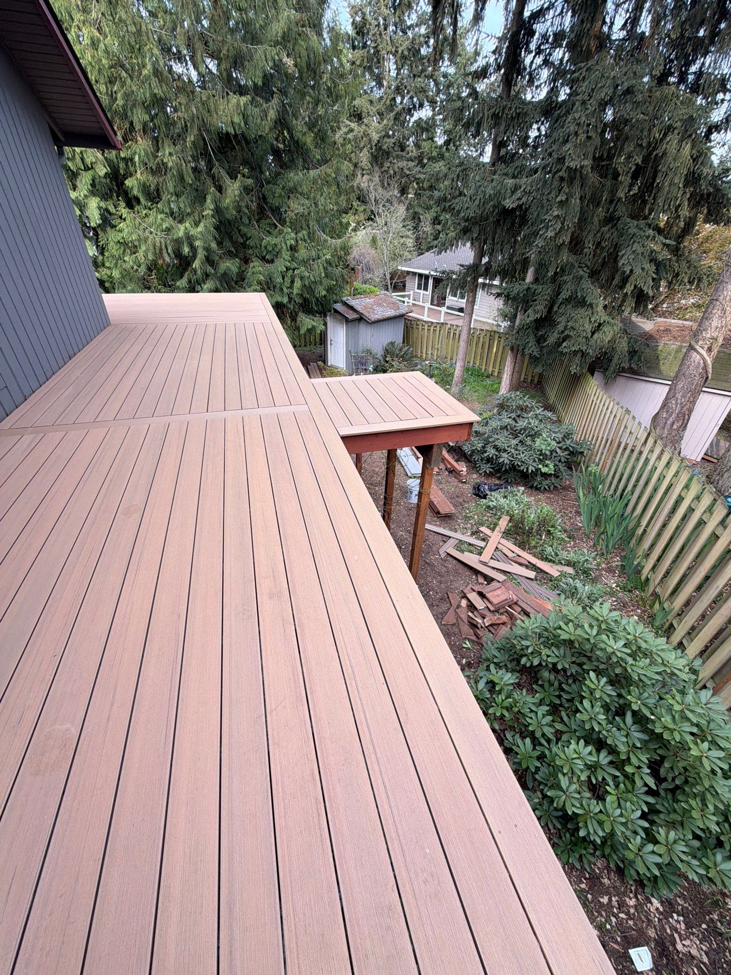 Elevated TimberTech Composite Deck Replacement With Black Metal Railings by Emerald City Energy