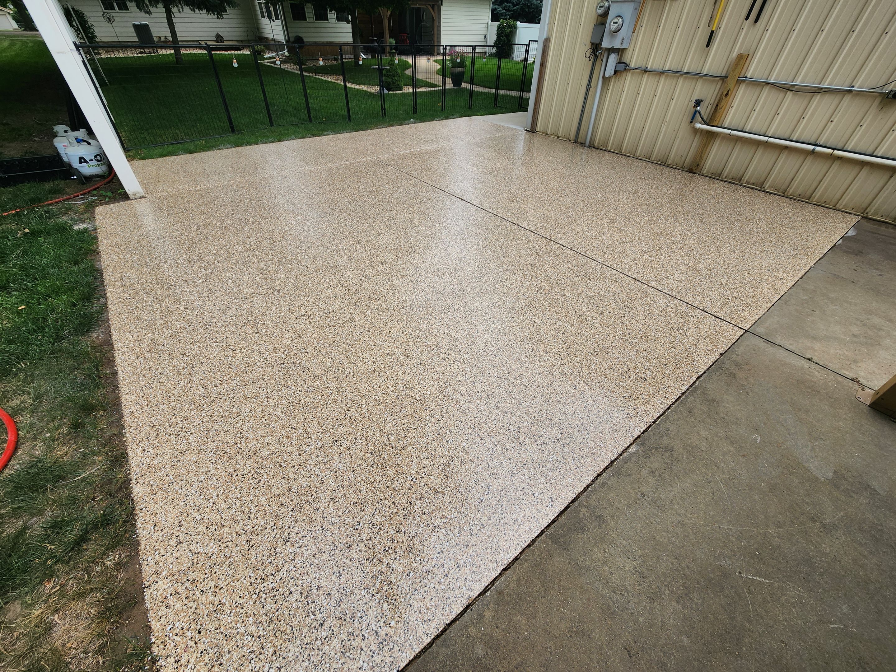 Speckled Epoxy Concrete Patio Coating Installation in Hurley by Select Painting, Coatings & Garage Cabinets