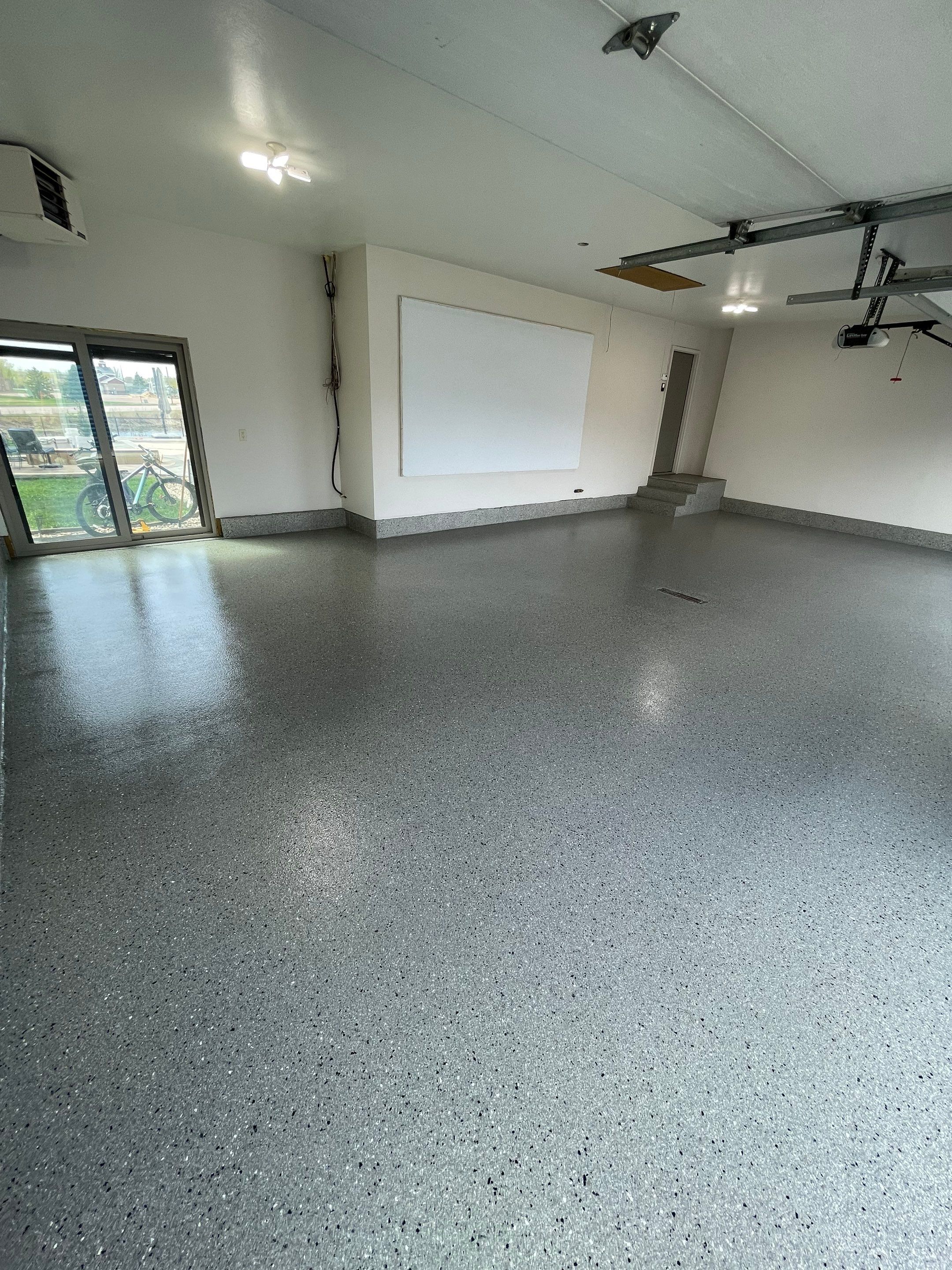 Residential Garage Floor Coating with Grey Speckled Epoxy Finish by Select Painting, Coatings & Garage Cabinets