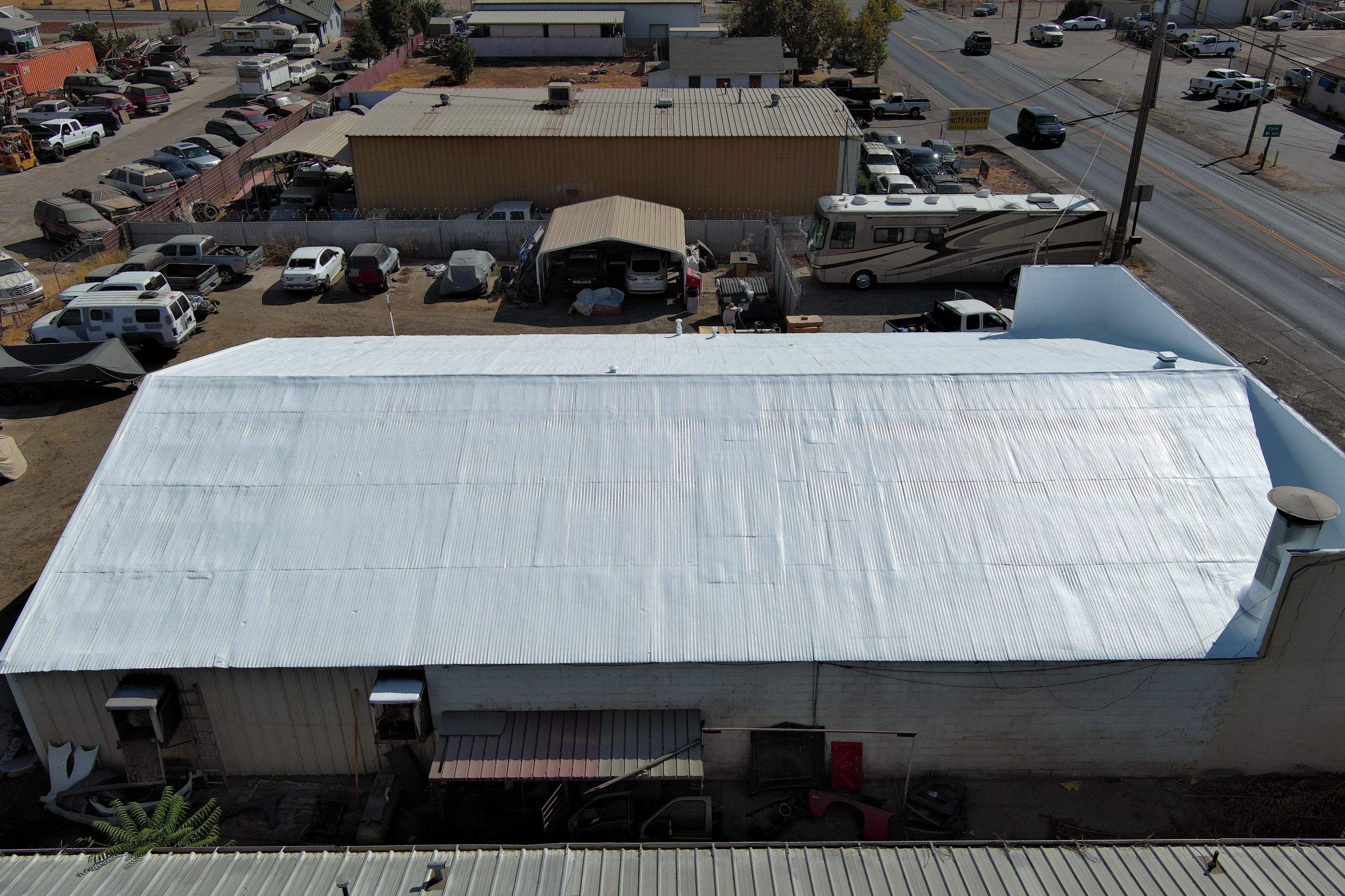 Spray foam and coatings using Conklin Benchmark/ PUMA XL acrylic coatings over metal and foam by Straight Edge Roofing Inc