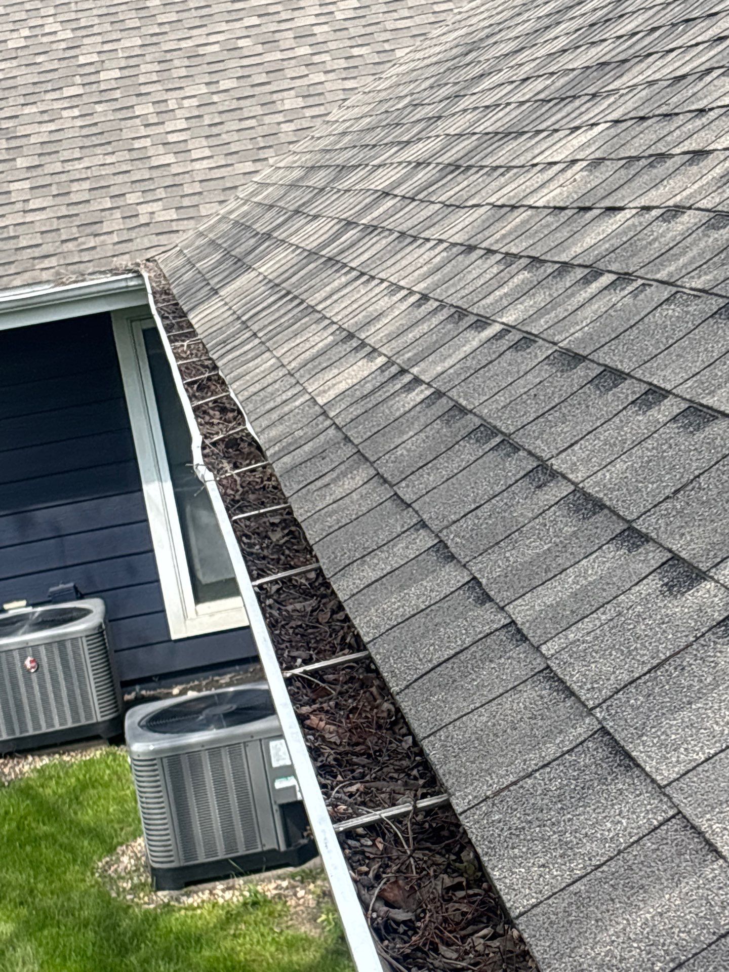 Commercial gutter cleaning Ames, IA before photo with filled gutters