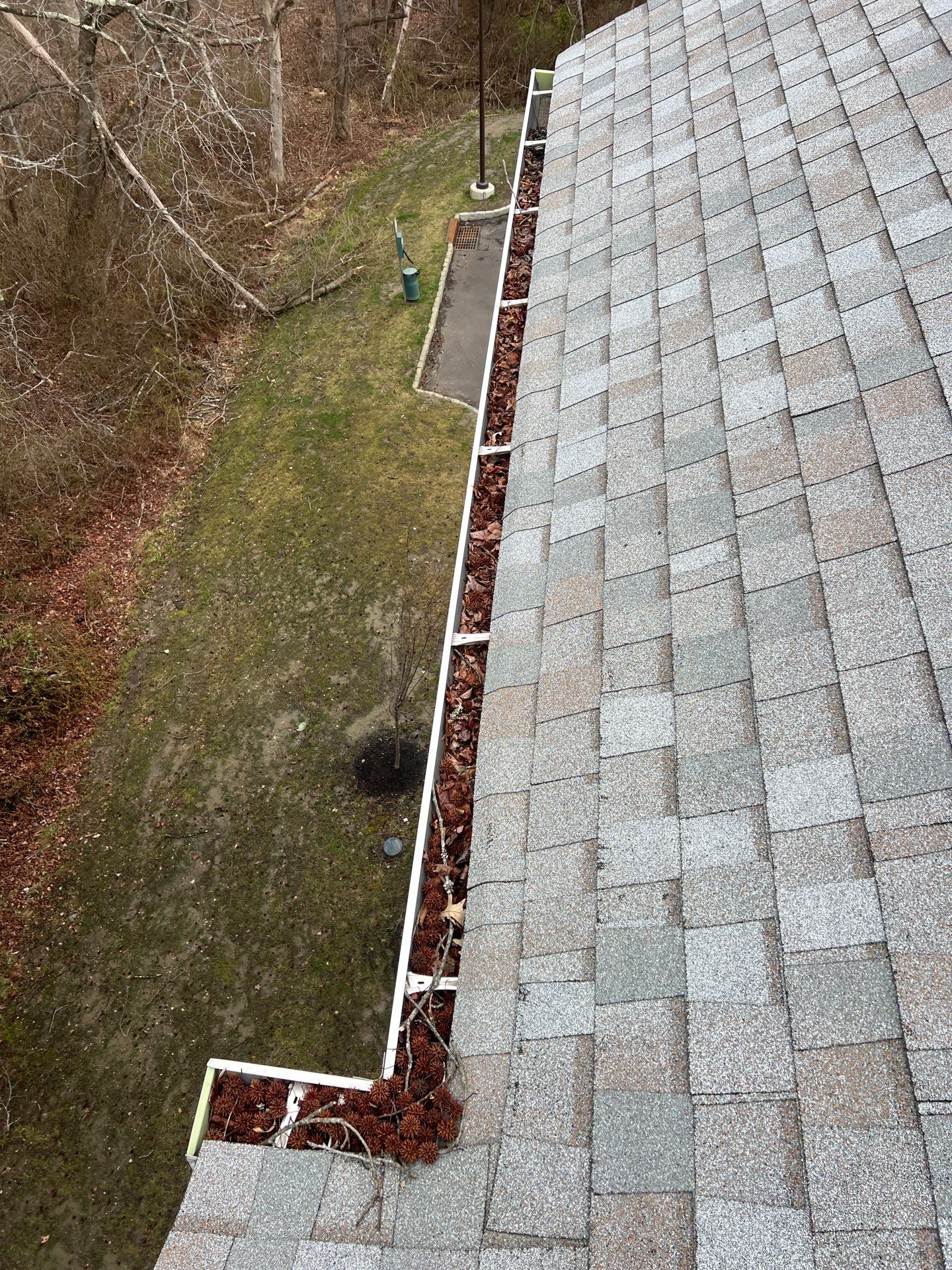Commercial gutter cleaning New Jersey before photo with filled gutters