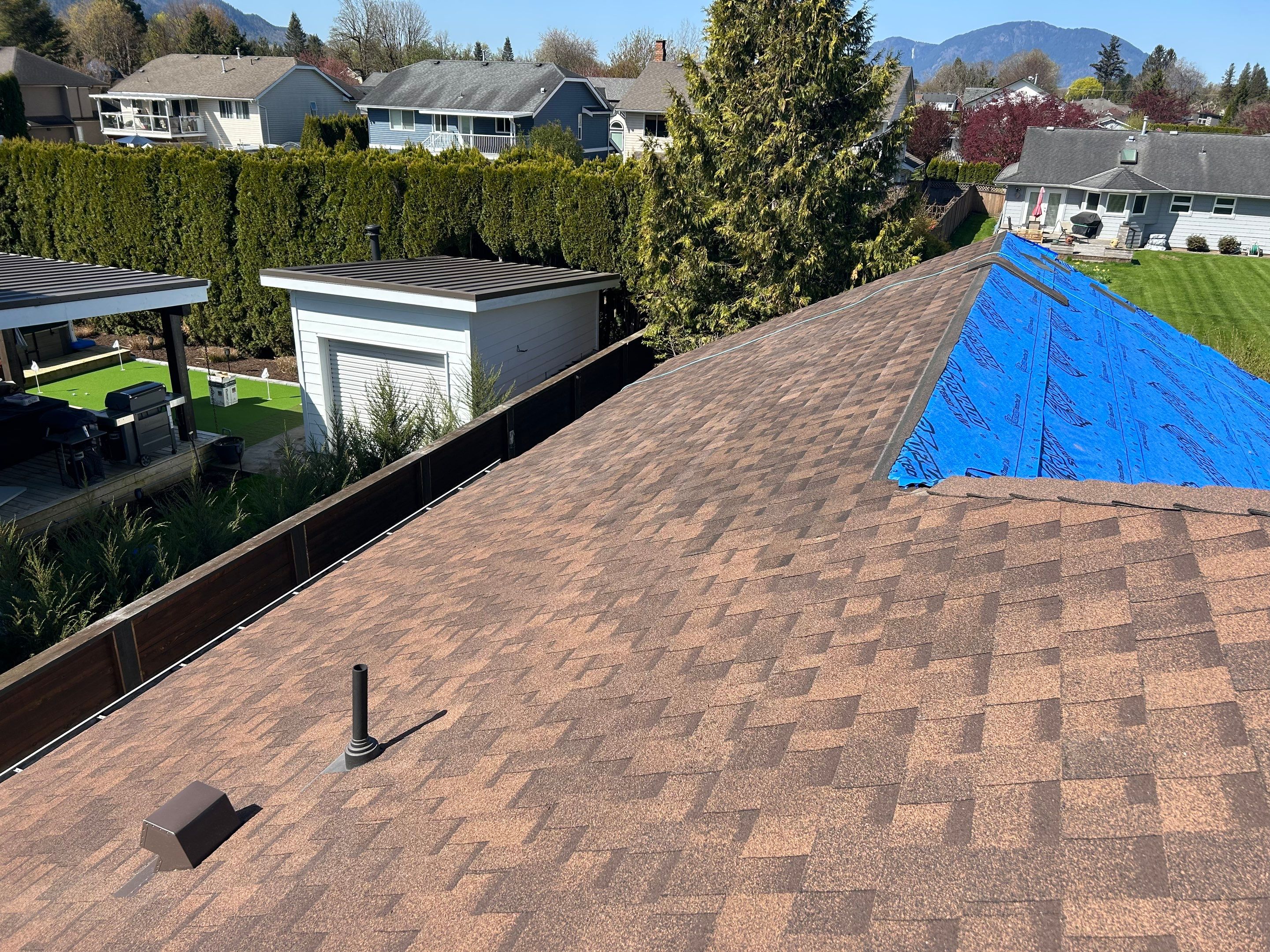 Residential patio roof extension with IKO Dual Brown shingles by Top Notch Roofing Inc
