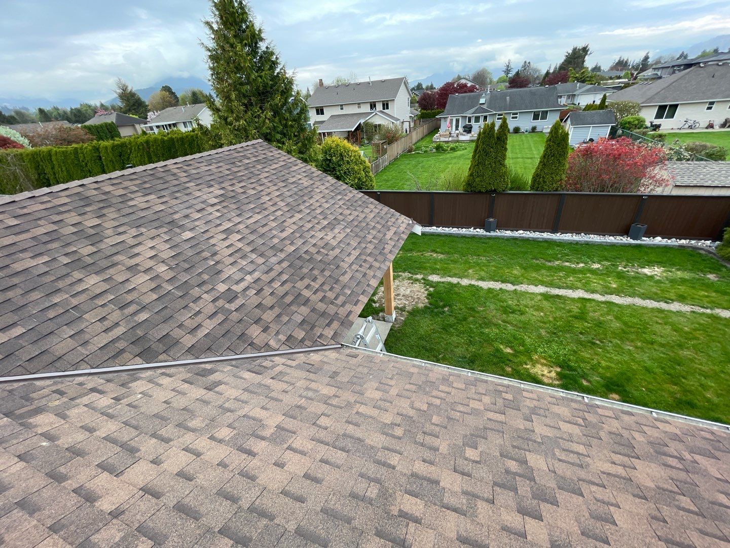 Residential patio roof extension with IKO Dual Brown shingles by Top Notch Roofing Inc