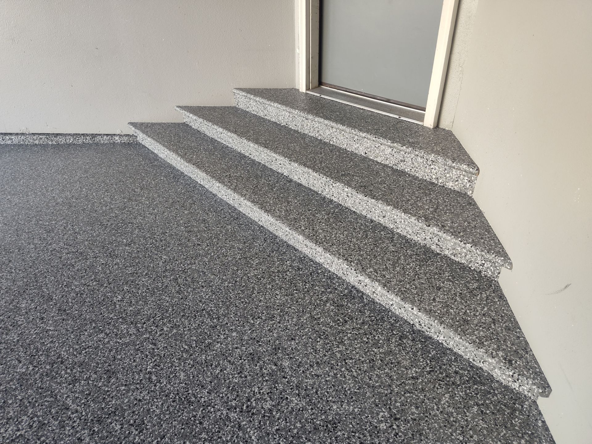Close Up View of This Customer's New Flake Coating by Revival Concrete Coatings