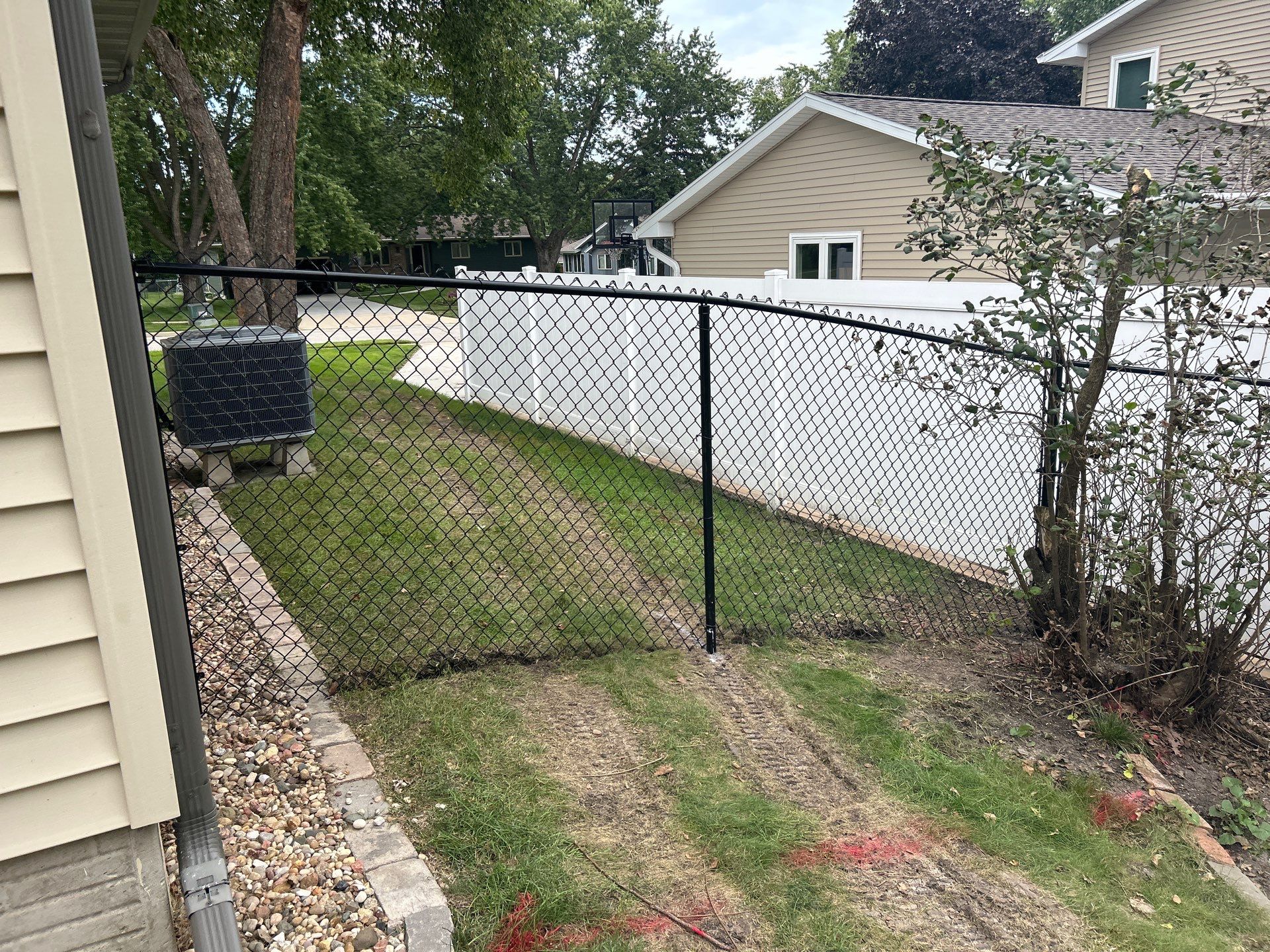 Black Vinyl-Coated Chain Link Fence Installation in Waterloo by Perfect Picket Fence and Stain