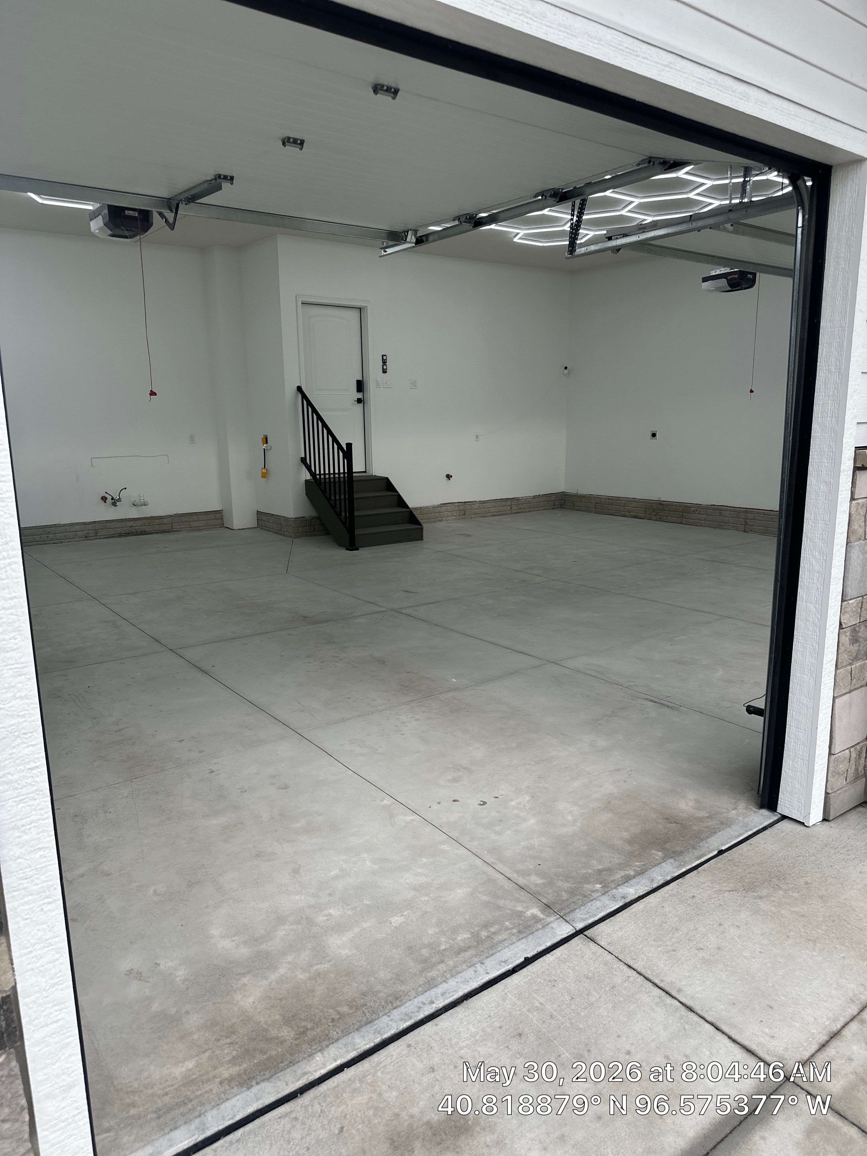 Three-Stall Garage Epoxy Floor Coating and LED Lighting in Lincoln by Goat Coatings