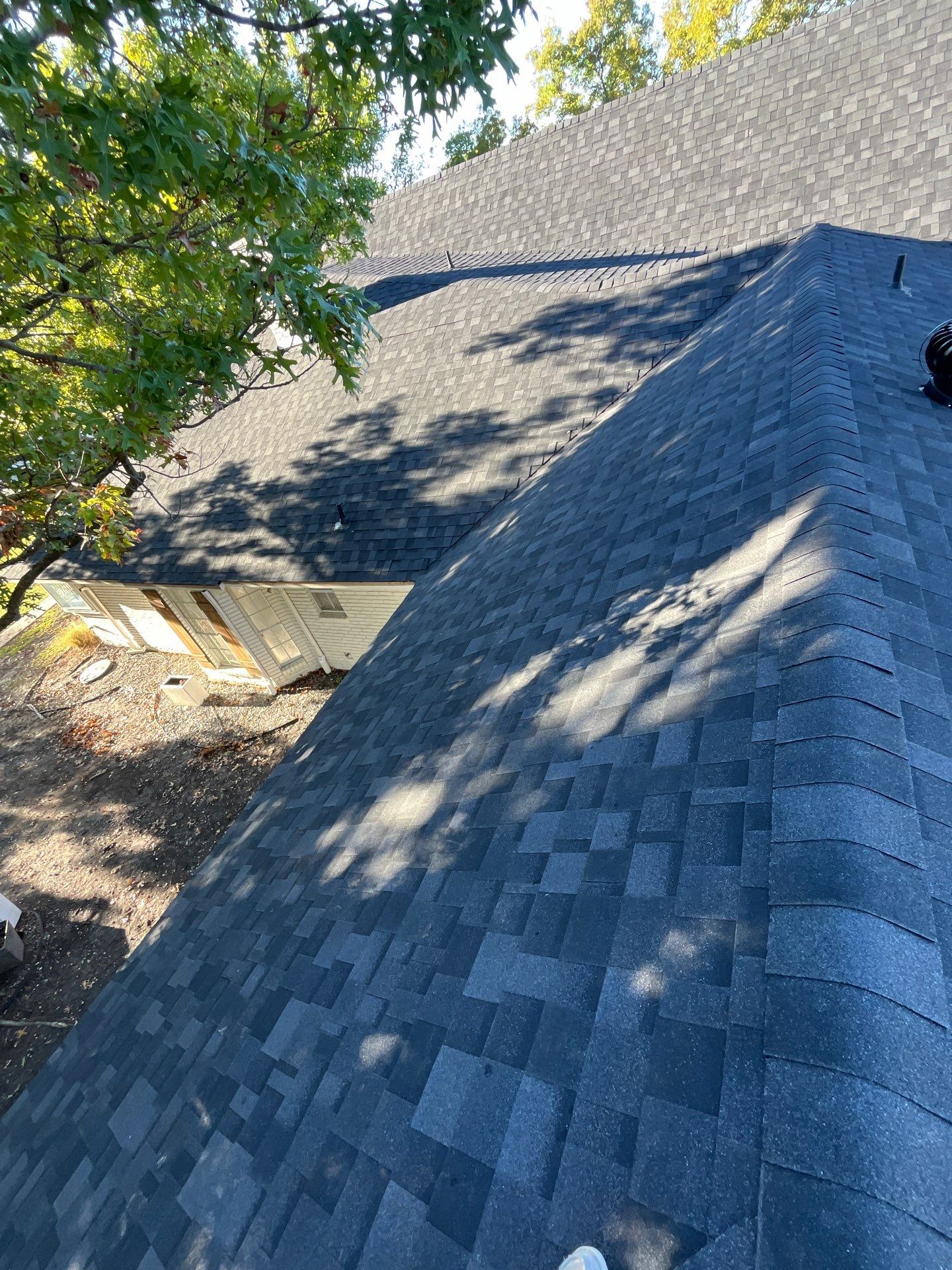 White brick with IKO Granite Black by Tejas Roofworks + Restoration