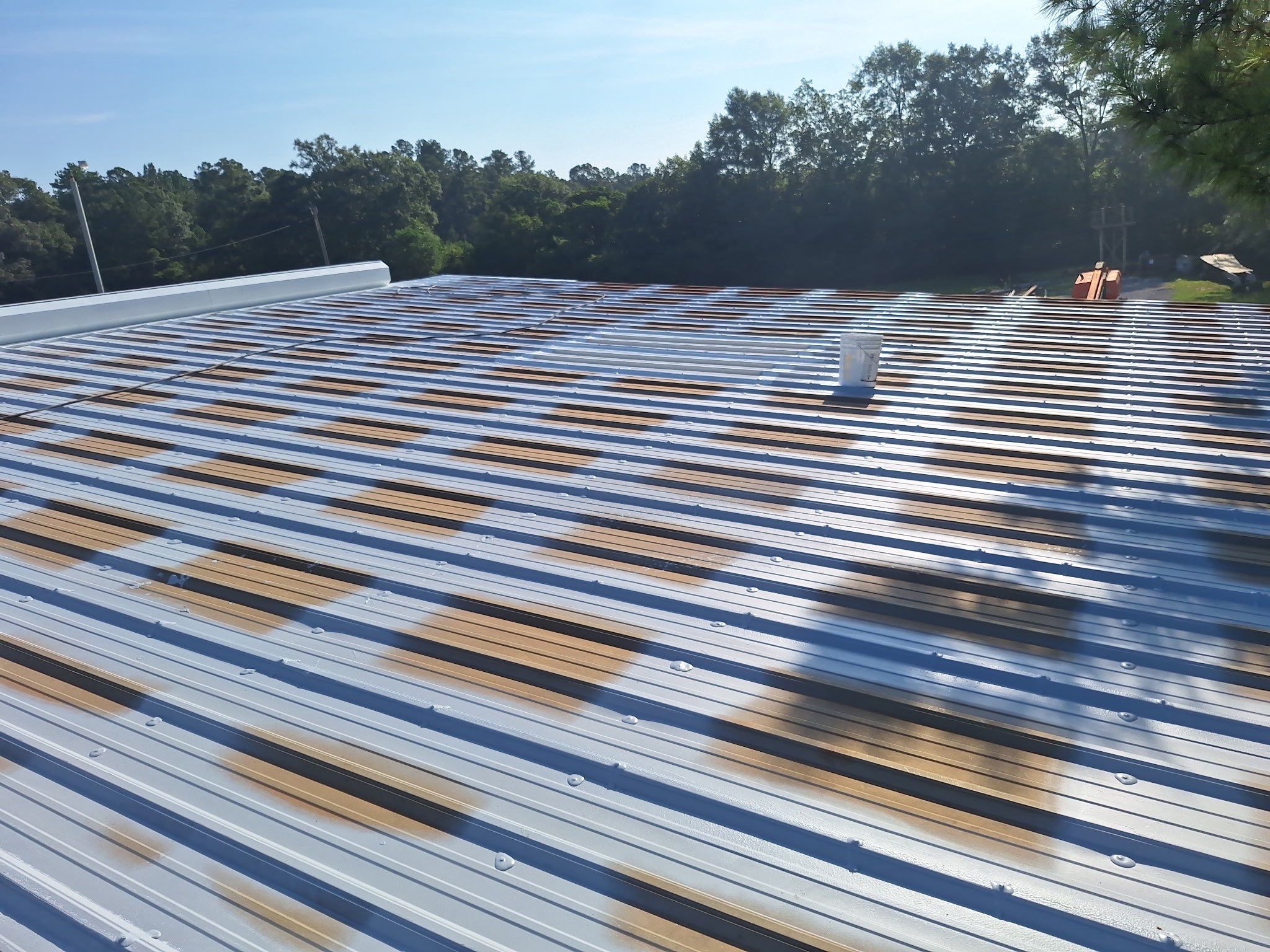 Commercial Metal Roof Restoration with White Protective Coating by Southern Roof Solutions