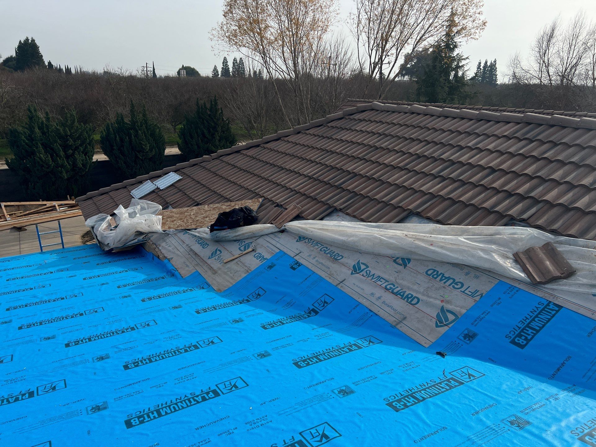 Tile, Metal, and TPO roofing project (new construction) by Straight Edge Roofing Inc