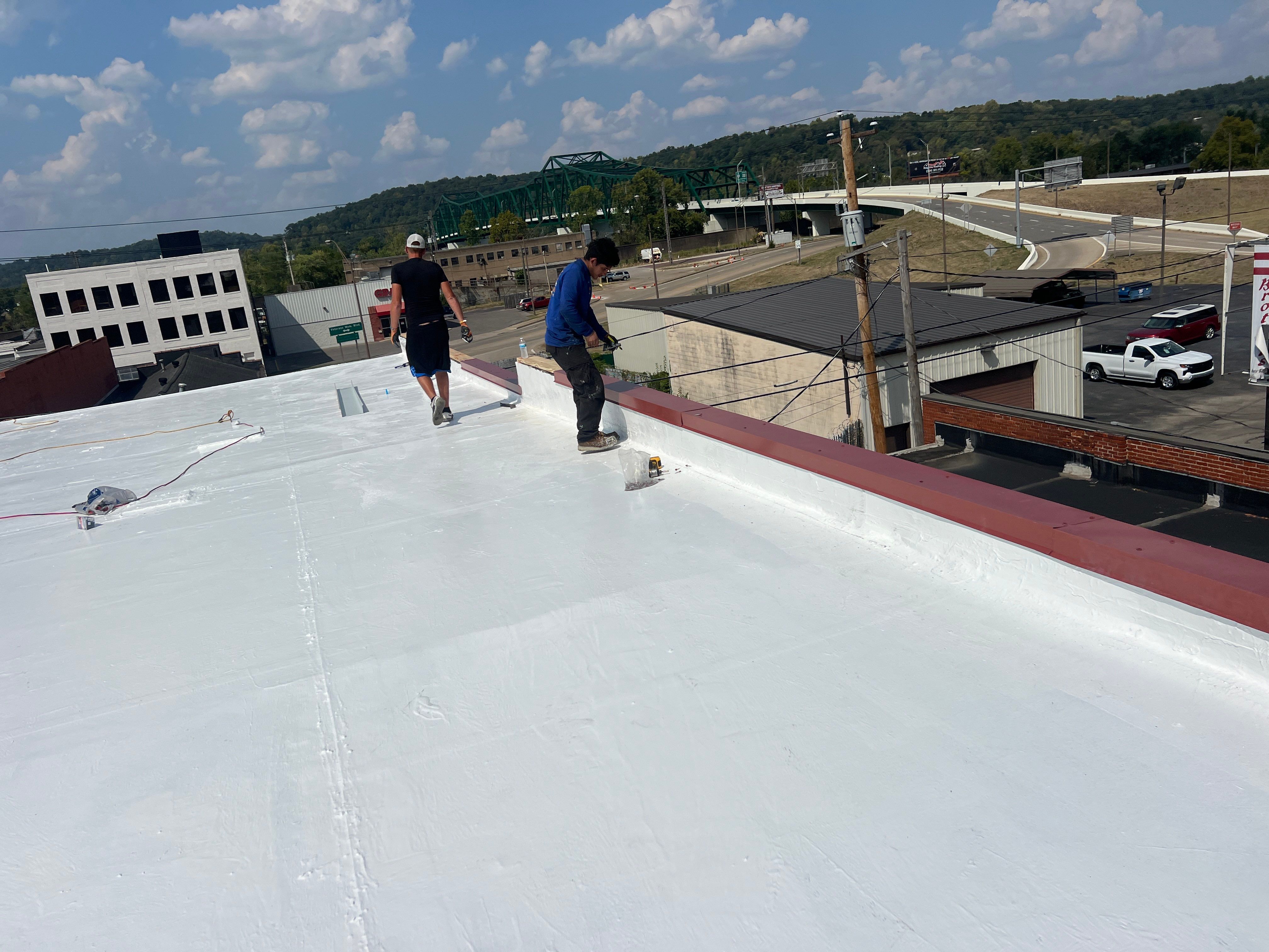 Commercial Roofing Installation using smartcoat Roof coating by Fahey Roofing + Contracting