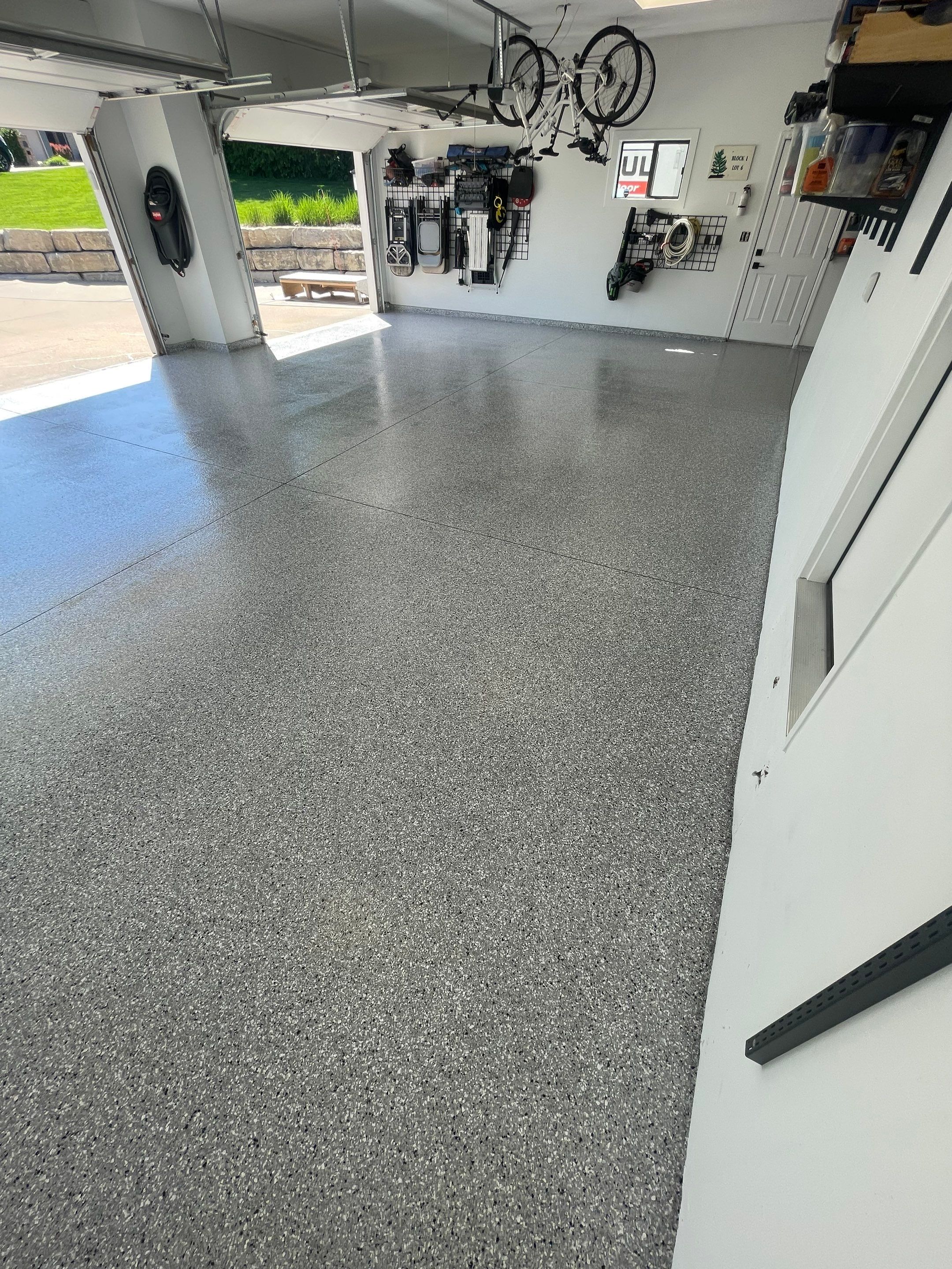 Feather Grey Garage Floor Coating Installation in Sioux Falls by Select Painting, Coatings & Garage Cabinets