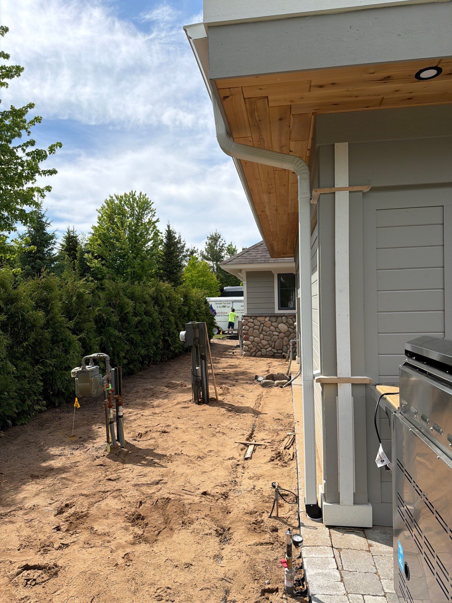 White Gutter and Downspout Installation for a Petoskey Home by Rainbow Seamless Systems