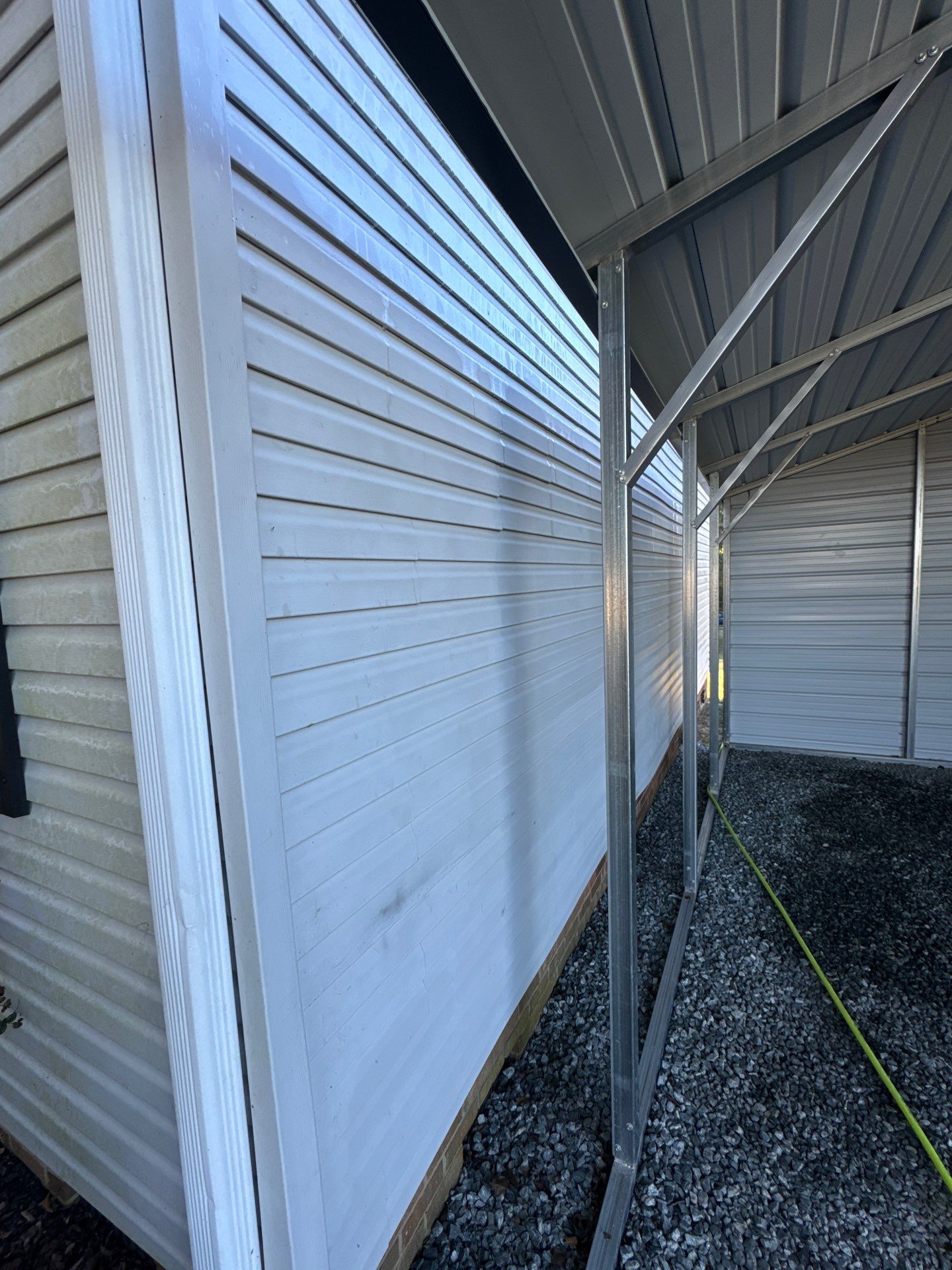 the service being done is cleaning the horizontal siding and metal awning using pressure washing techniques to remove dirt and grime