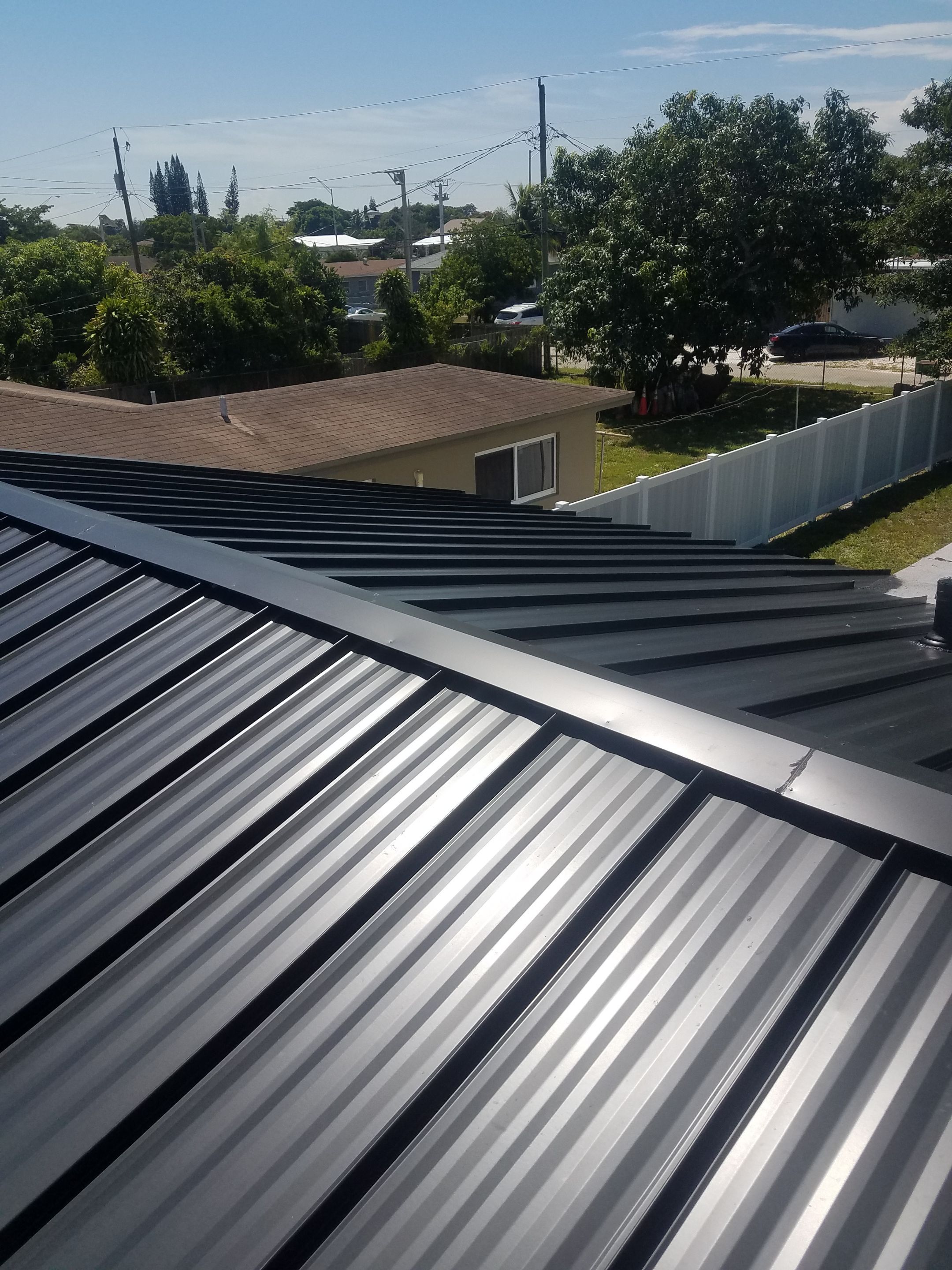 Standing Seam Metal & Flat Re-Roof using 1.5" Nail Strip 24ga Black Matte Kynar Coated Standing Seam Metal Panels by Morton Roofing, Inc.