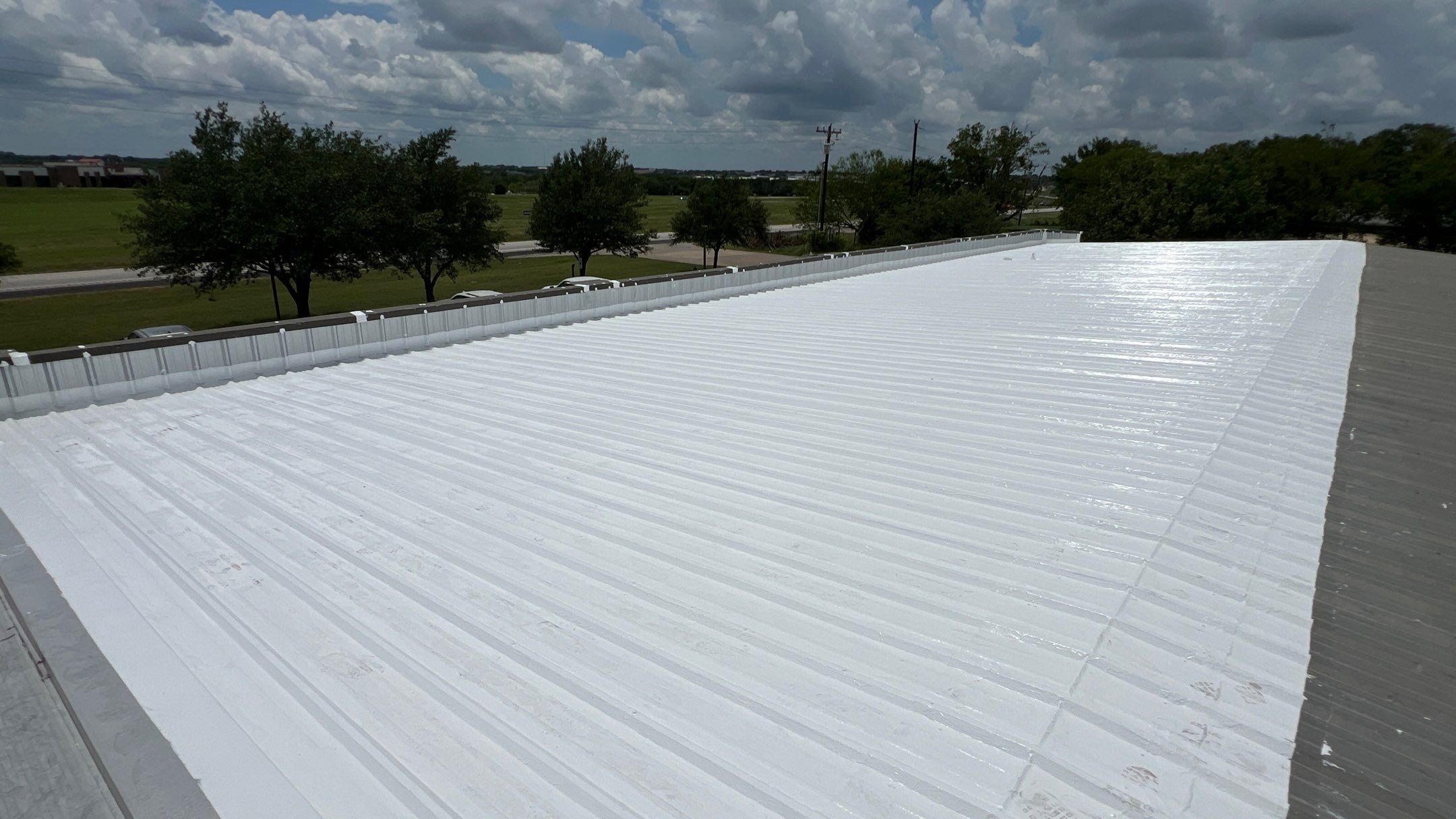 Commercial Roofing Installation using TRP #924 Eterna-Sil Premium Silicone Roof Coating by Harvey Roofing & Construction