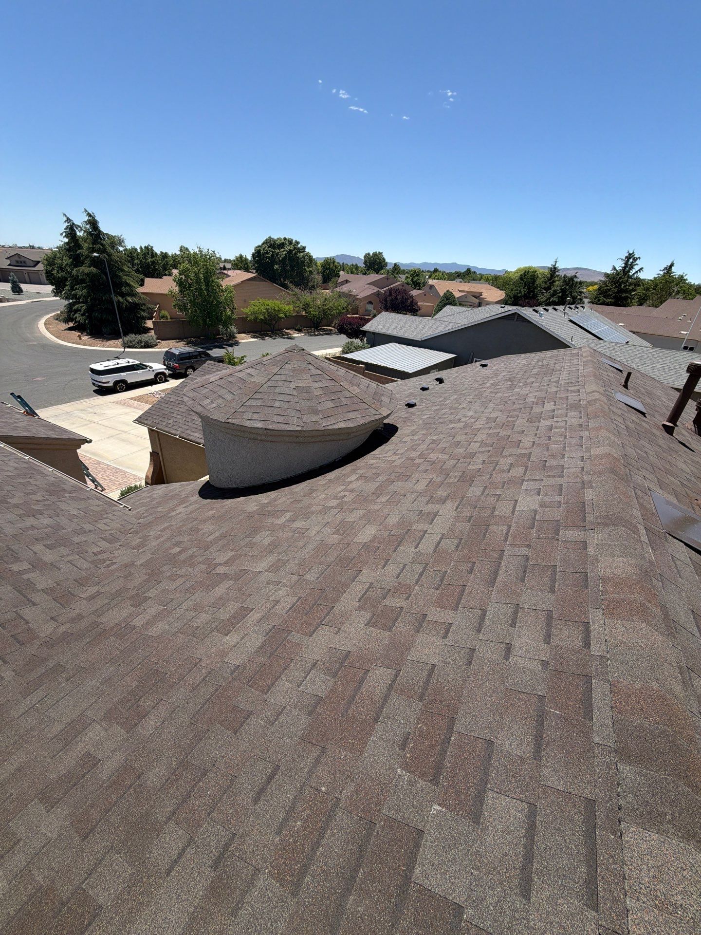 Residential Roofing Installation with Architectural Shingles and Turret Detail by Badger Roofing