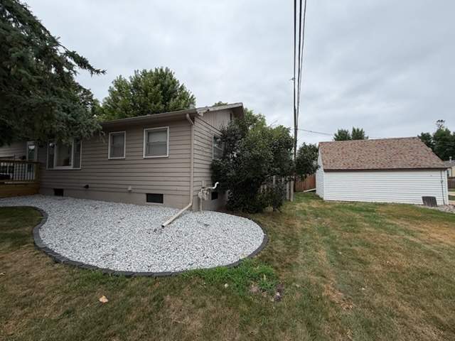 Dark Blue Exterior Painting and Trim Refresh in Sioux Falls by Select Painting, Coatings & Garage Cabinets