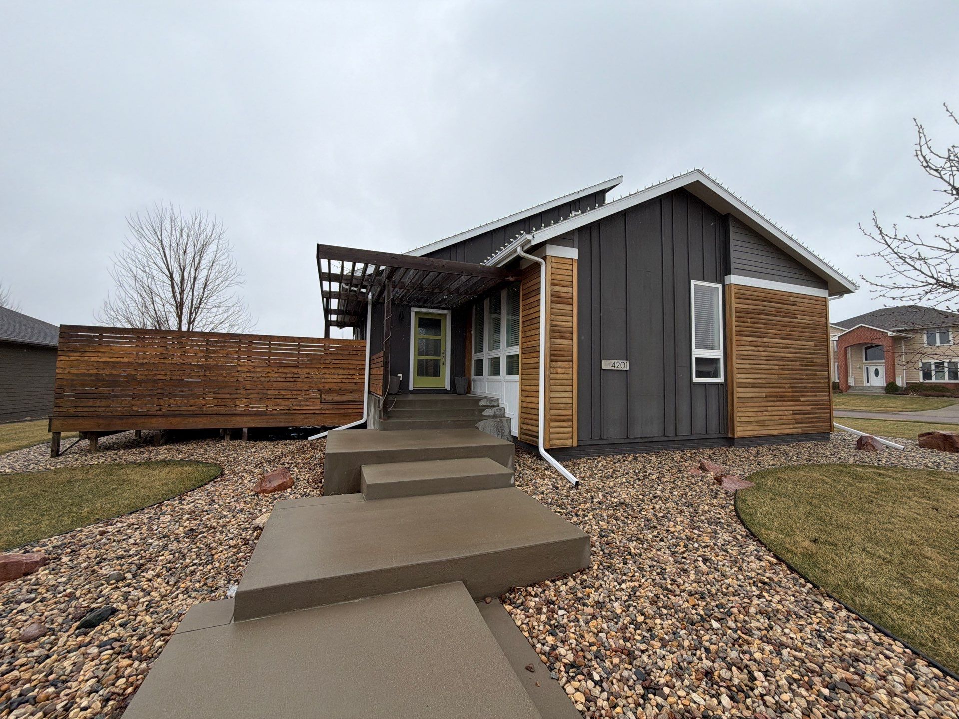 Modern Exterior Transformation Featuring Dark Board and Batten Siding in Sioux Falls by Select Painting, Coatings & Garage Cabinets