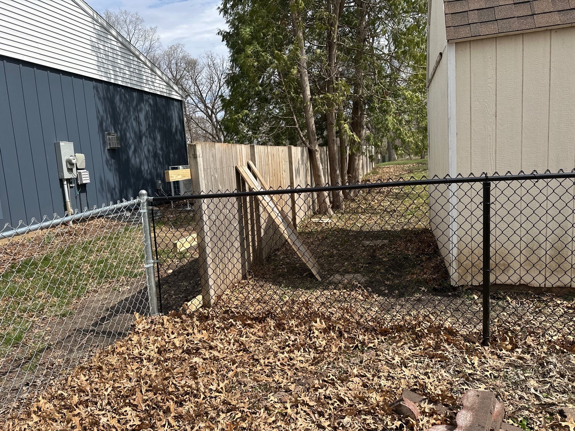 Black Vinyl-Coated Chain Link Fence Installation in Cedar Falls by Perfect Picket Fence and Stain