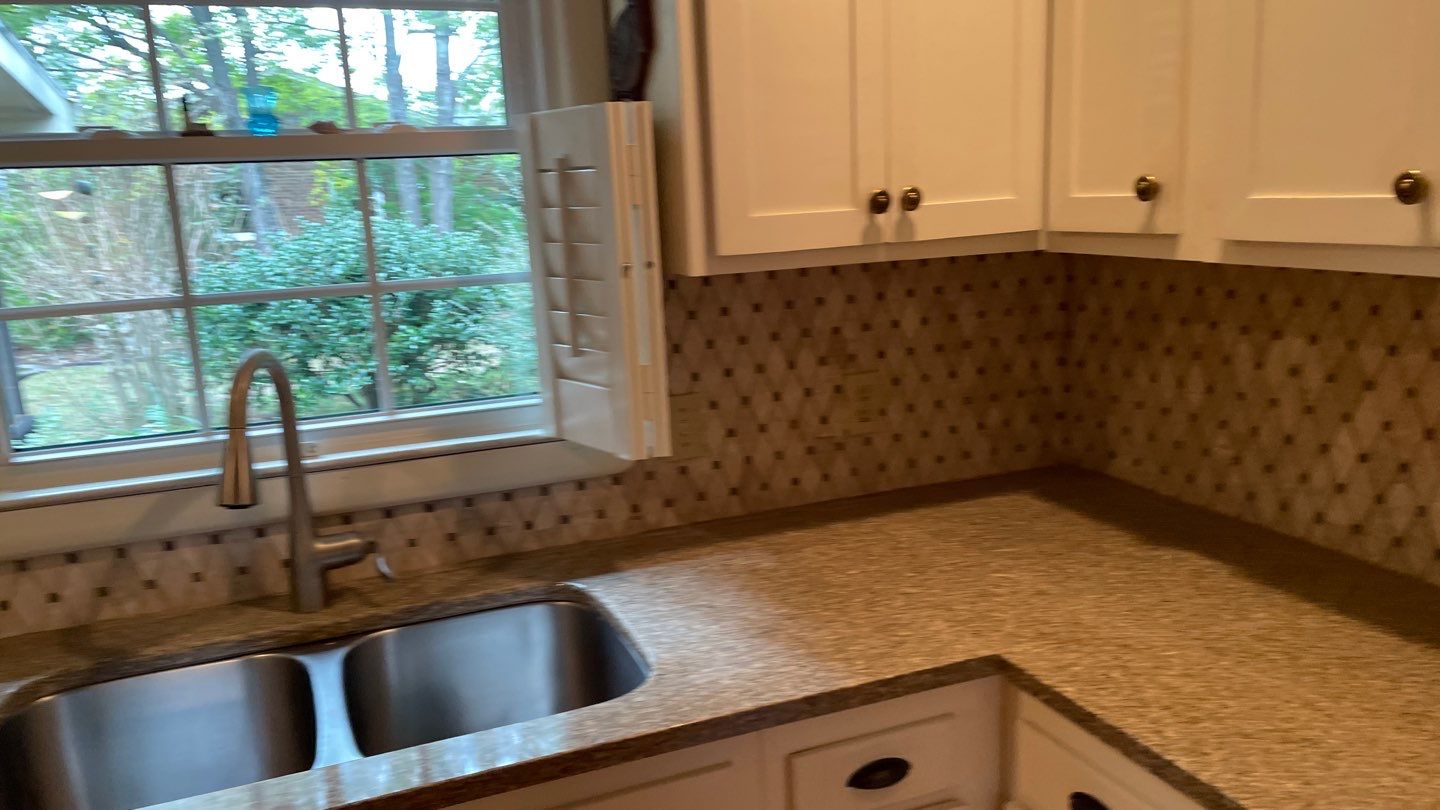 New Backsplash to Compliment the Countertops by Footprints Floors of Coastal Carolina
