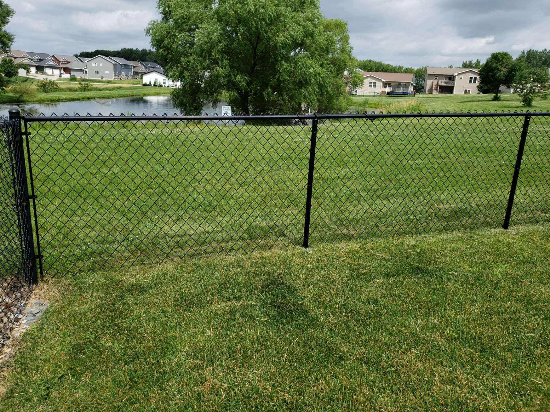 Black Vinyl Chain Link Perimeter Fence Installation in Waterloo by Perfect Picket Fence and Stain