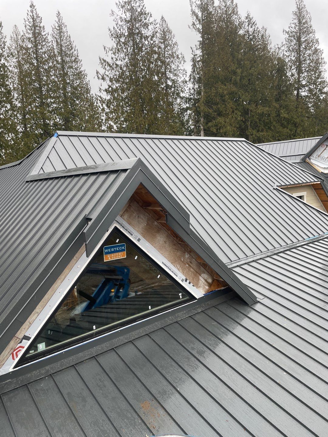 Residential Roofing Installation using 12" Prolok metal by Top Notch Roofing Inc