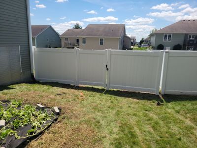 White Vinyl Privacy Fence and Ornamental Gate Installation in Janesville