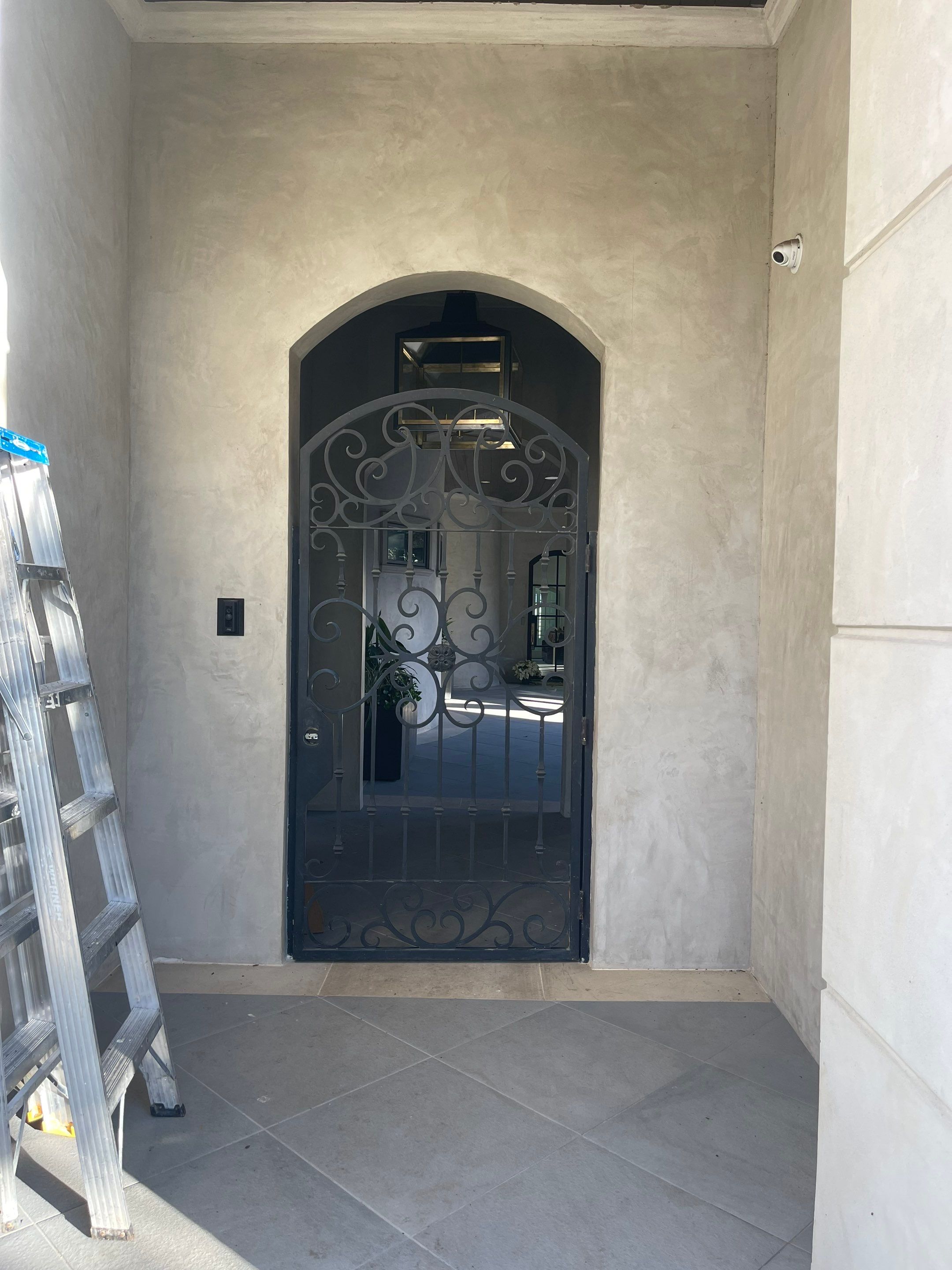 Arched Decorative Metal Security Gate Installation in Dallas by Solara Custom Living