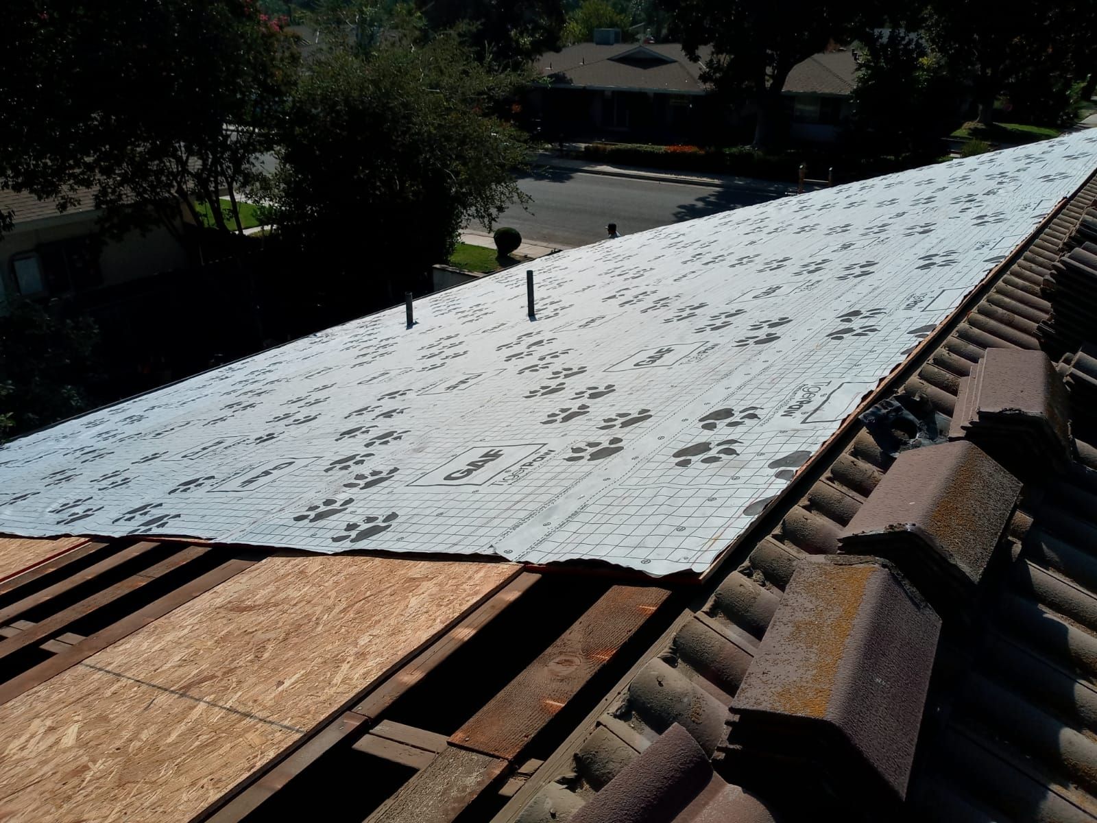Tile roof remodel/ install OSB sheathing under tile and replace using OSB board with new underlayment, tile, and battens by Straight Edge Roofing Inc